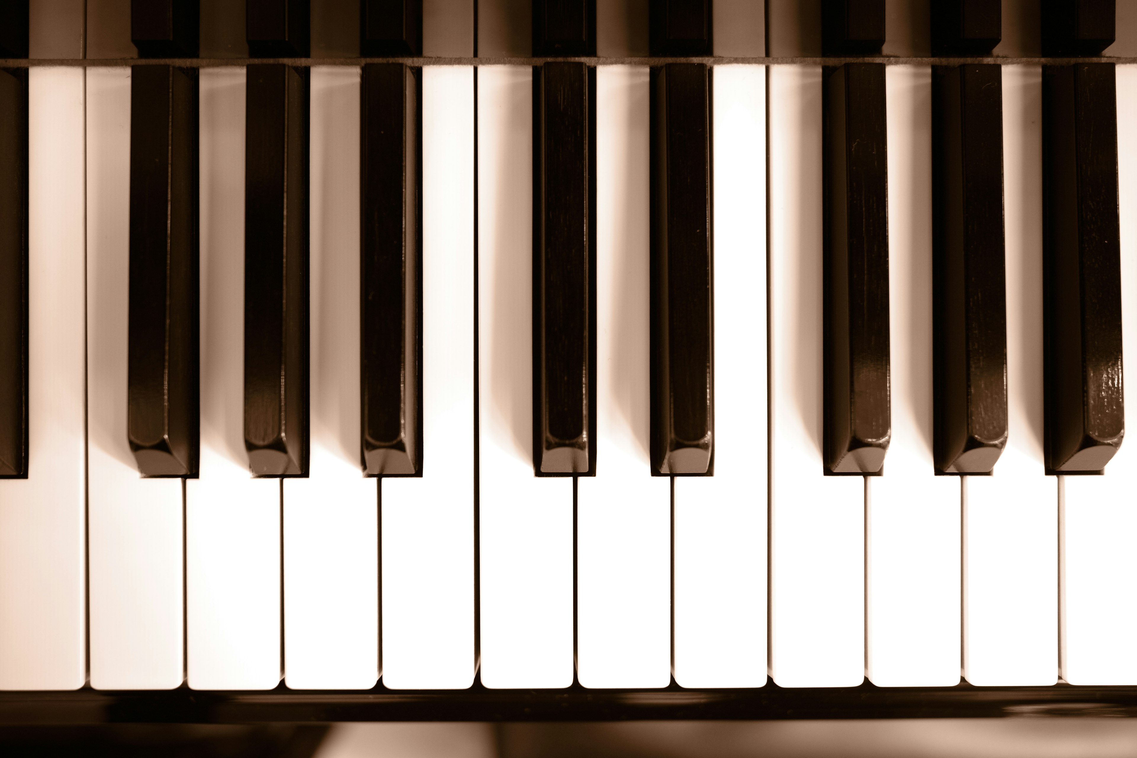 Close-up of a piano keyboard showing black and white keys