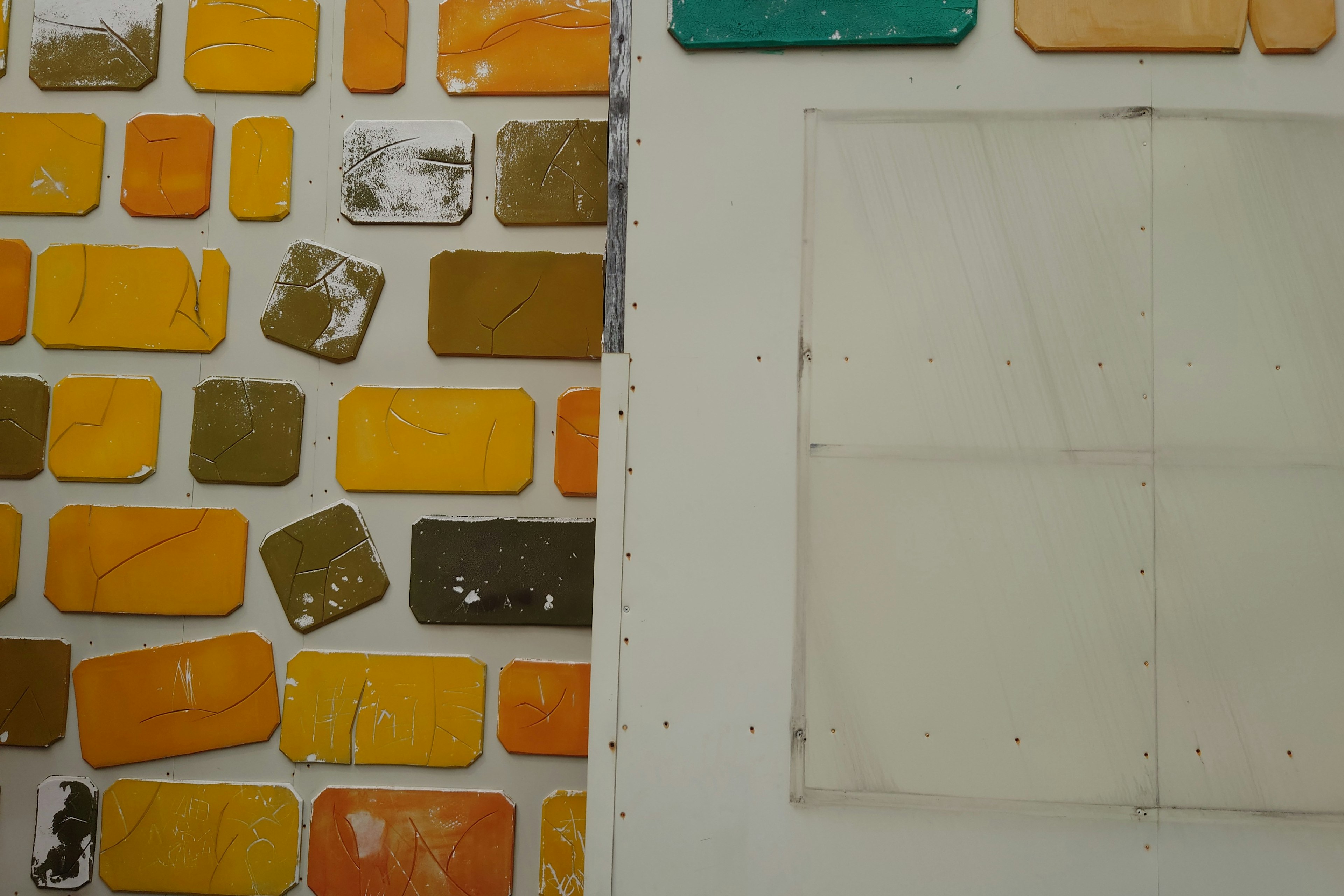 Image featuring multicolored tiles and a transparent plastic sheet