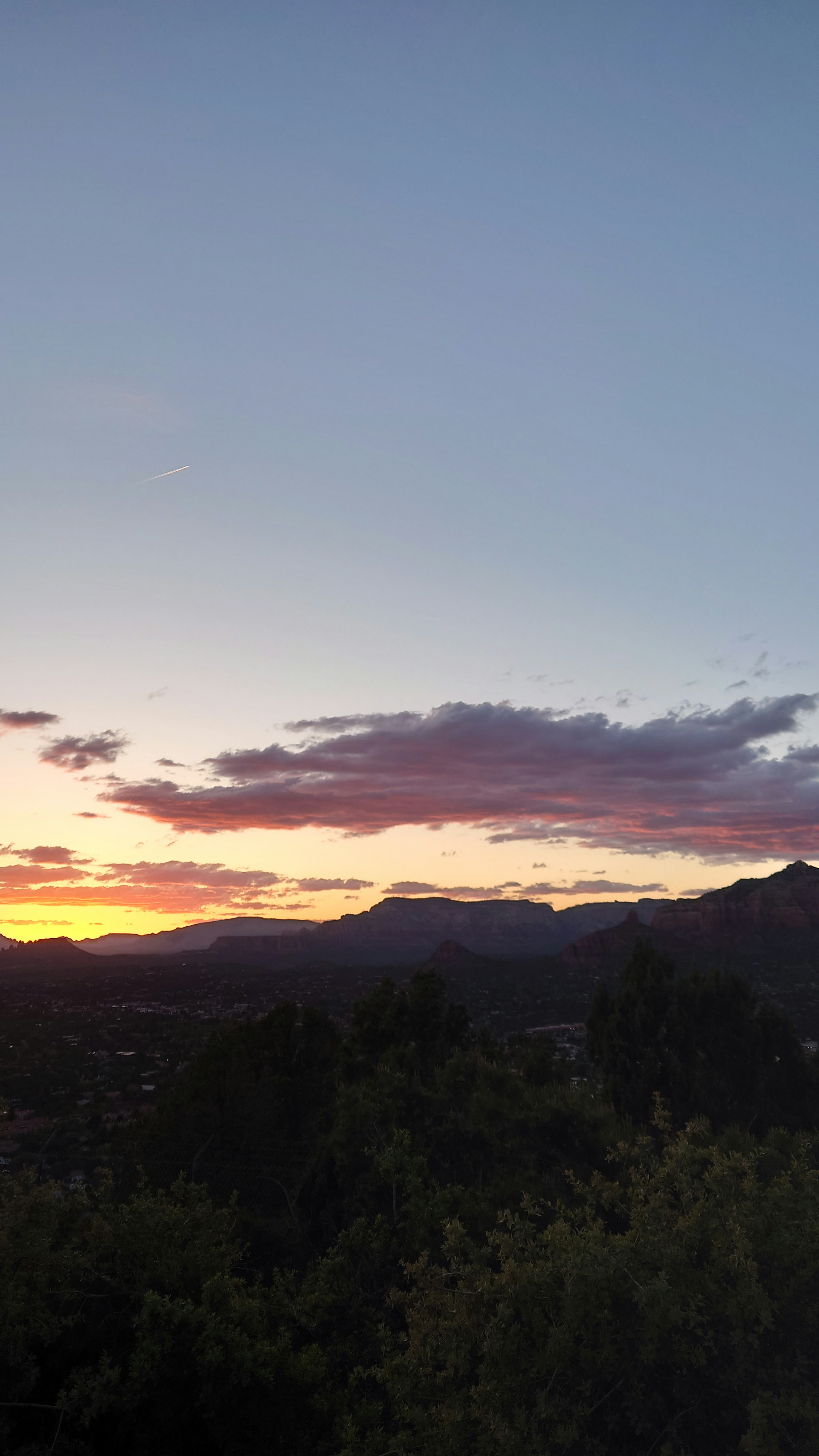 Landschaft mit Sonnenuntergangshimmel und silhouettierten Bergen