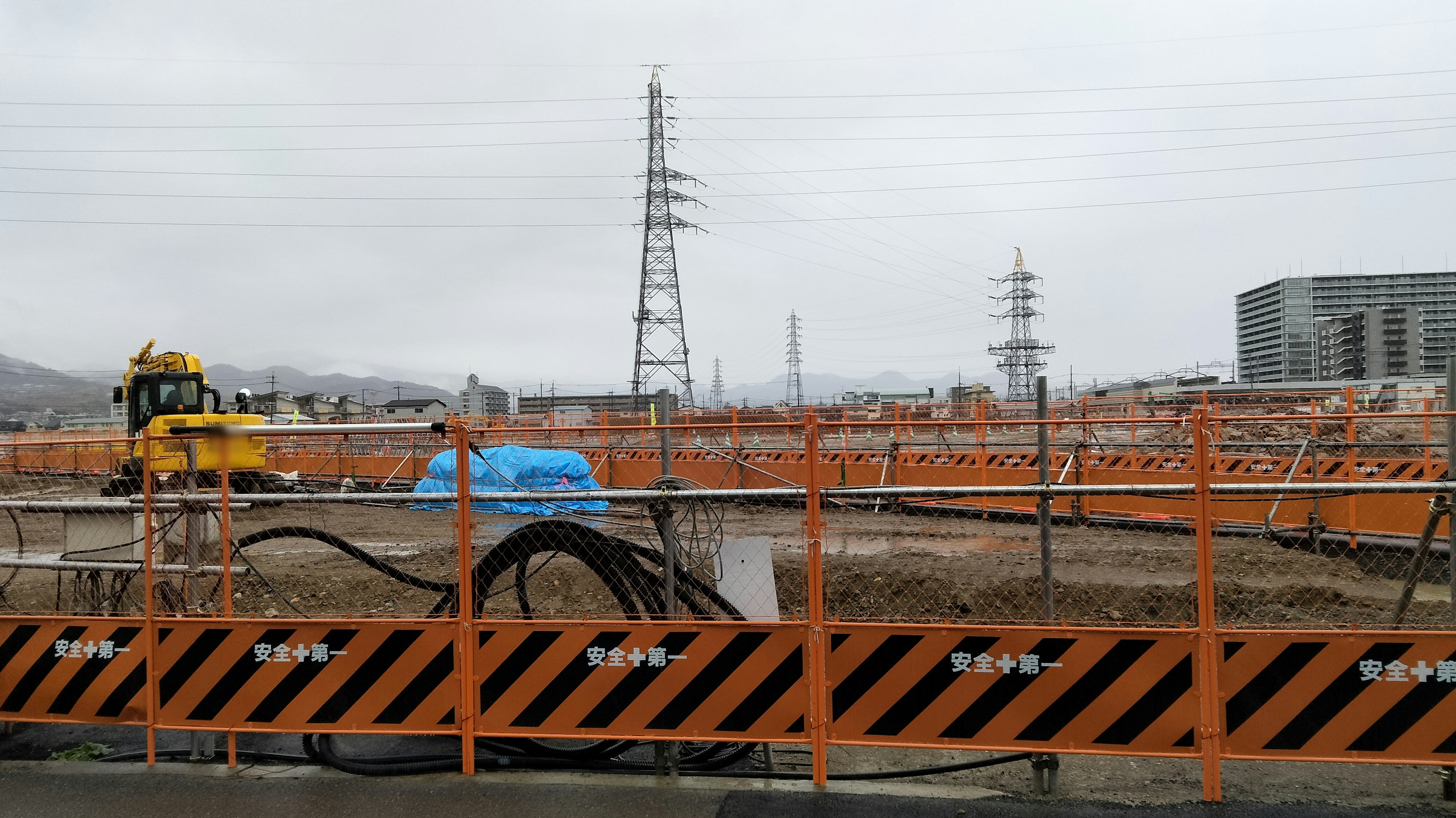 Construction site with orange barricades and heavy machinery