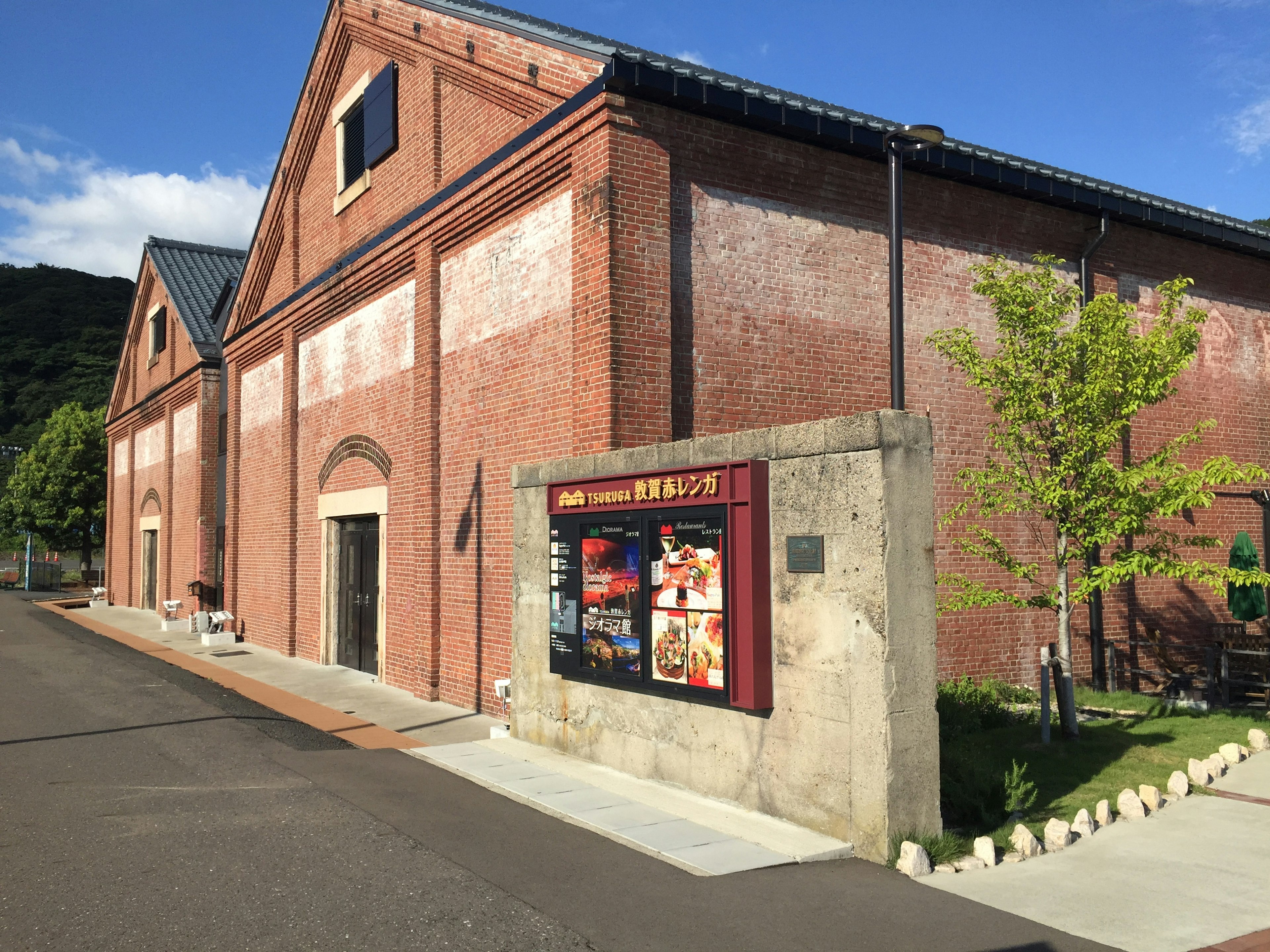 Extérieur d'un bâtiment en briques rouges avec un panneau de menu