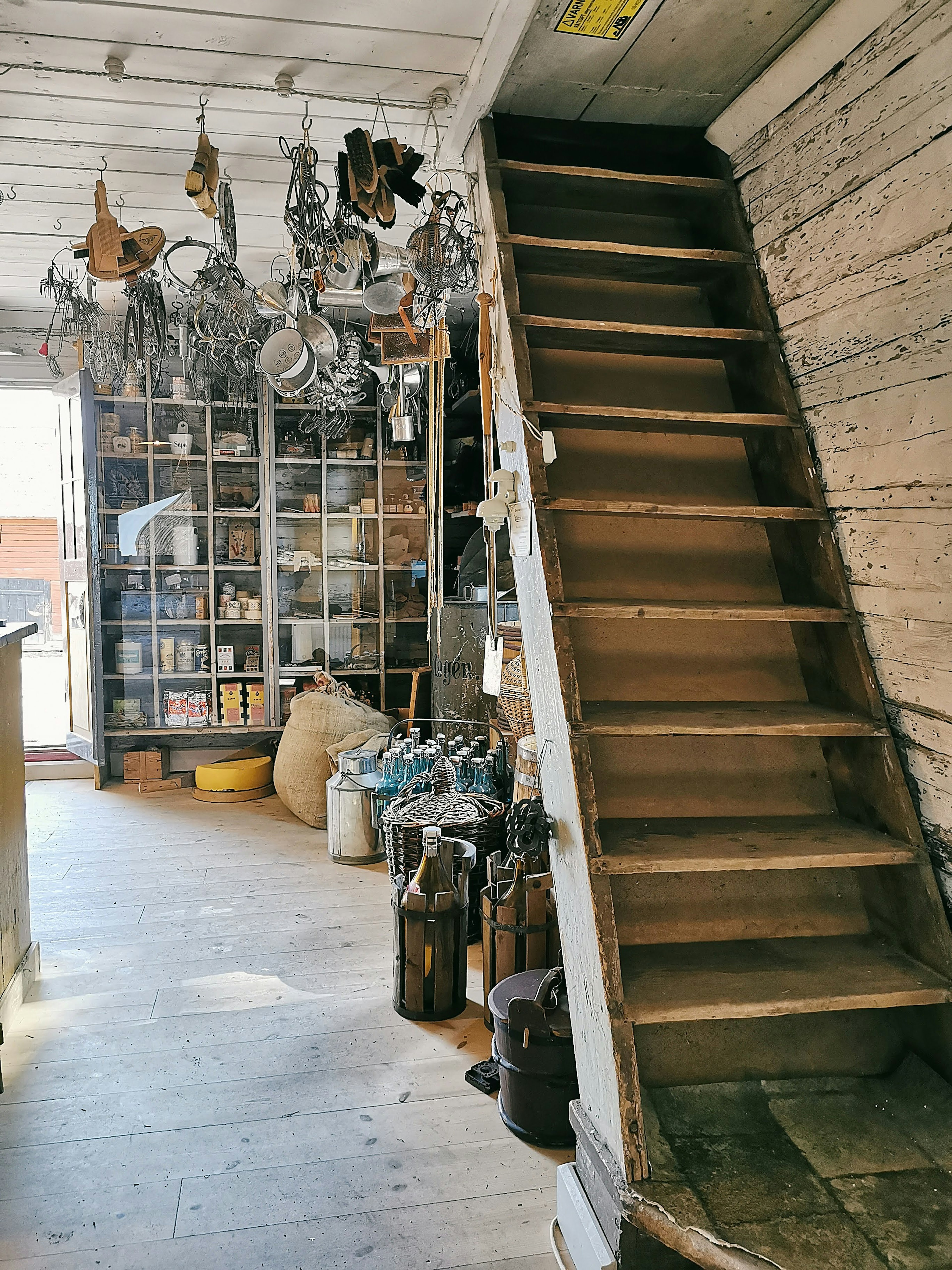 Interior scene featuring wooden stairs and vintage tools