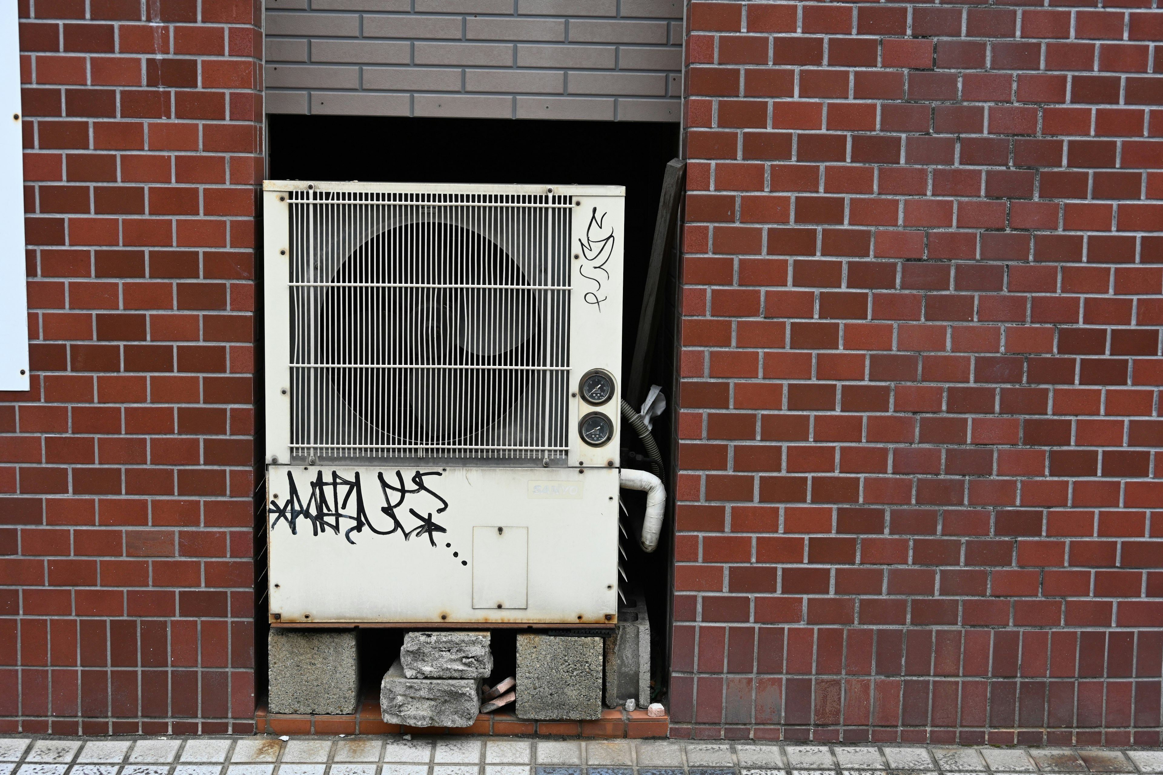 Air conditioning unit installed in a brick wall