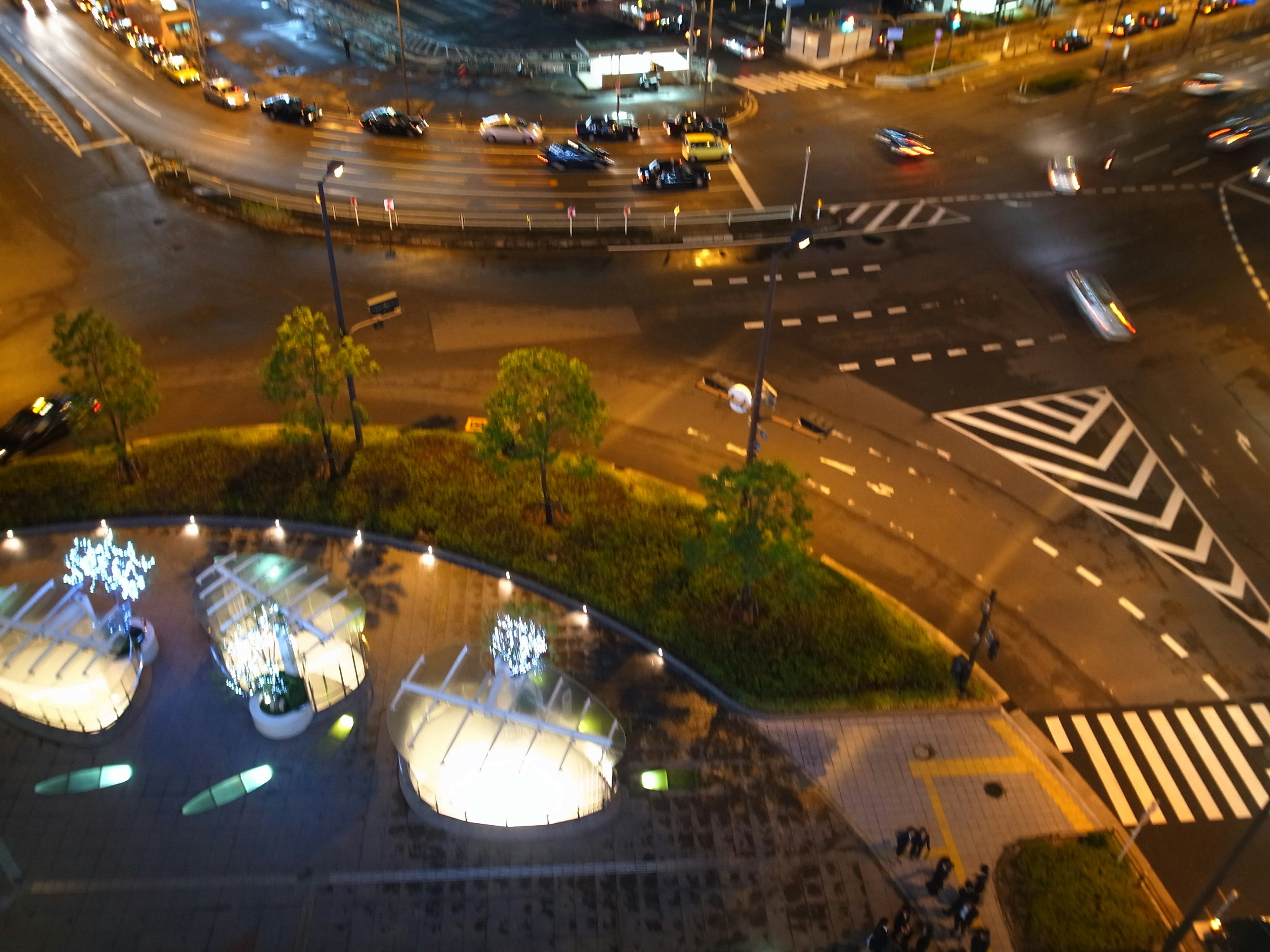 夜の街角の交差点と照明のある噴水