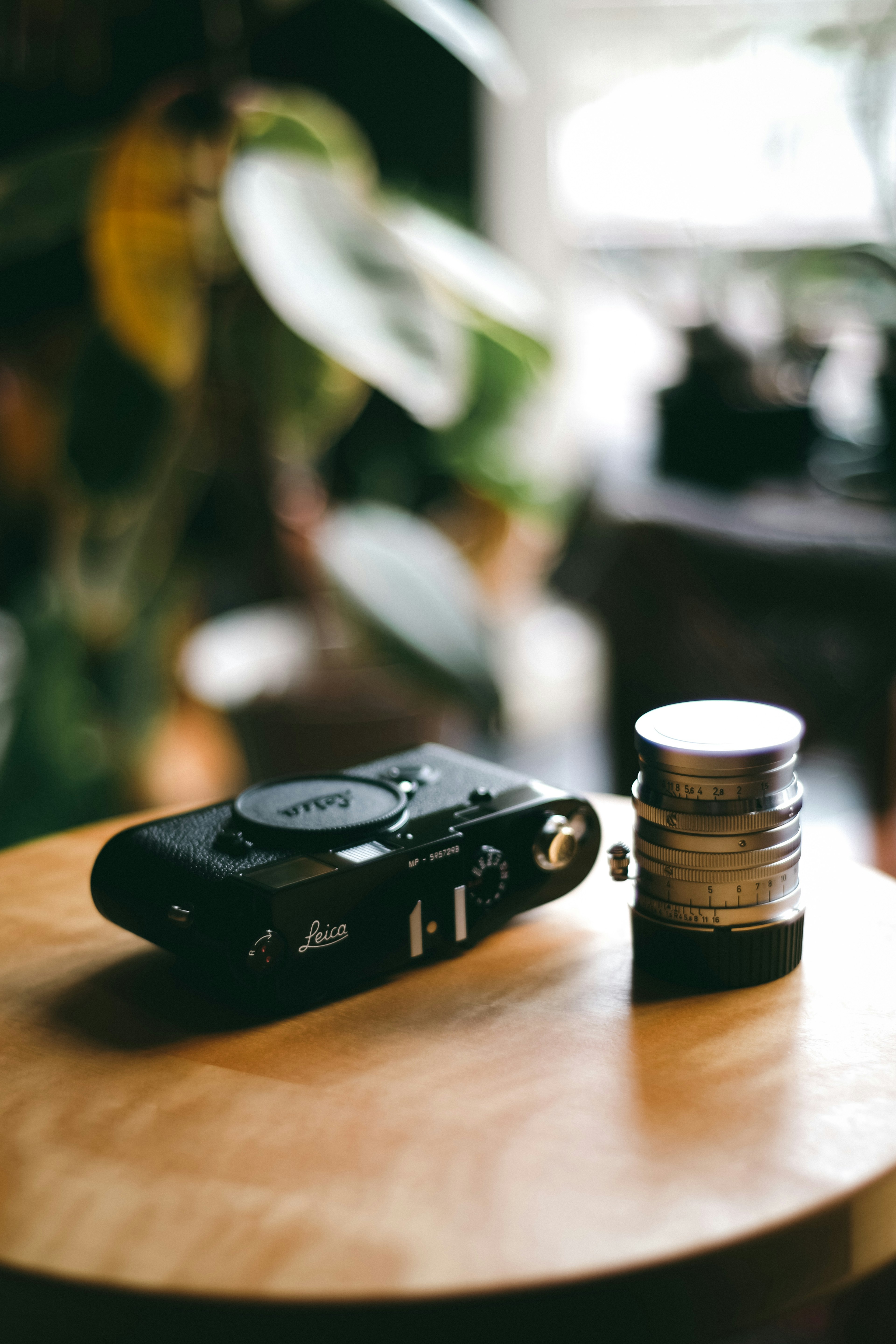 A black camera and lens placed on a wooden table