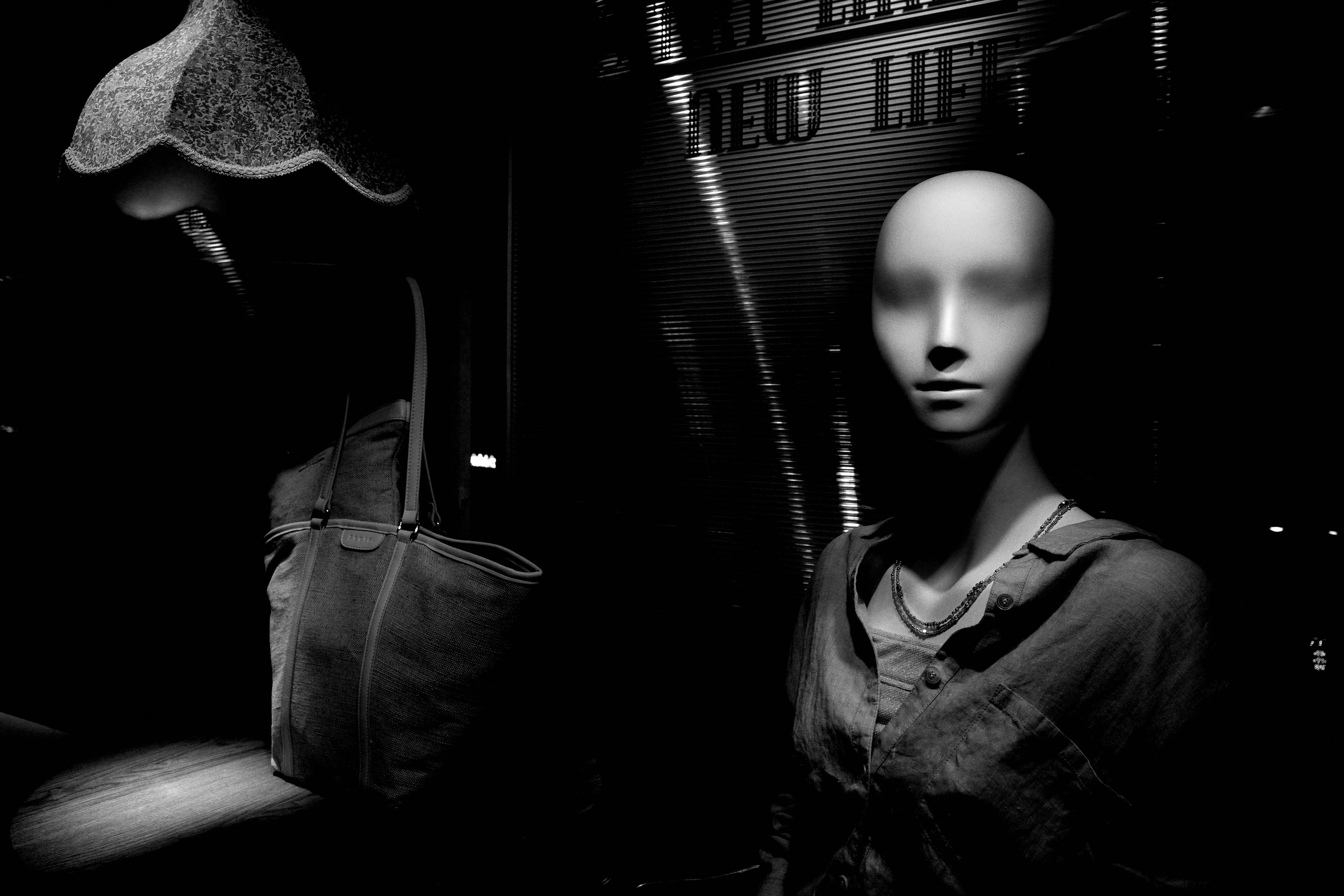 Black and white display featuring a mannequin and a bag