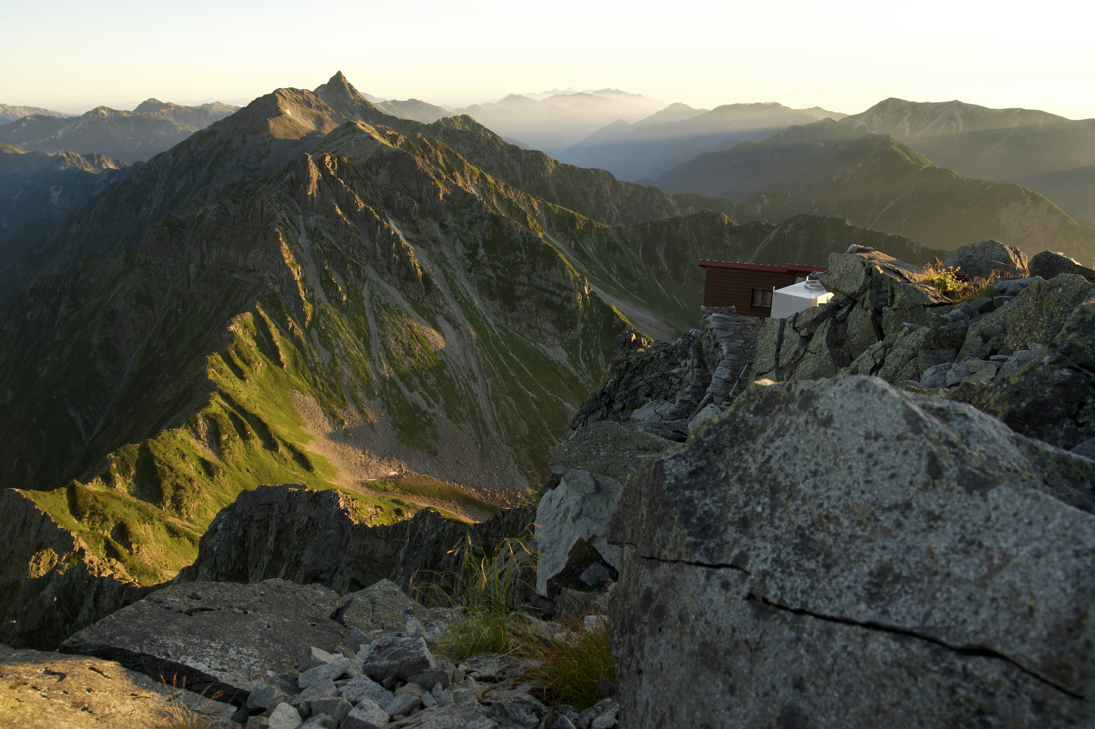 Stunning view from mountain peak lush green hills and rocky terrain