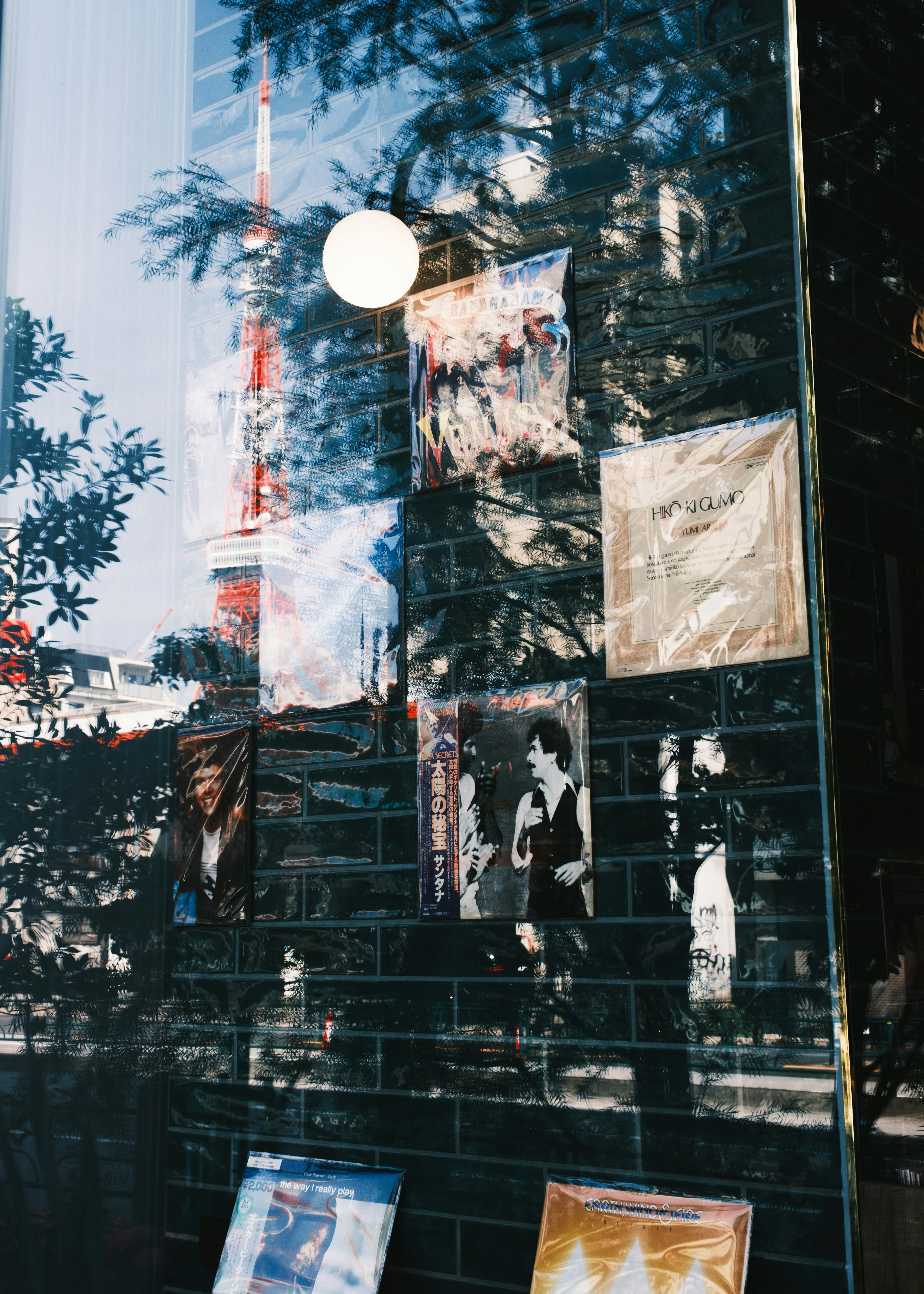 Posters reflected in a window with Tokyo Tower in the background