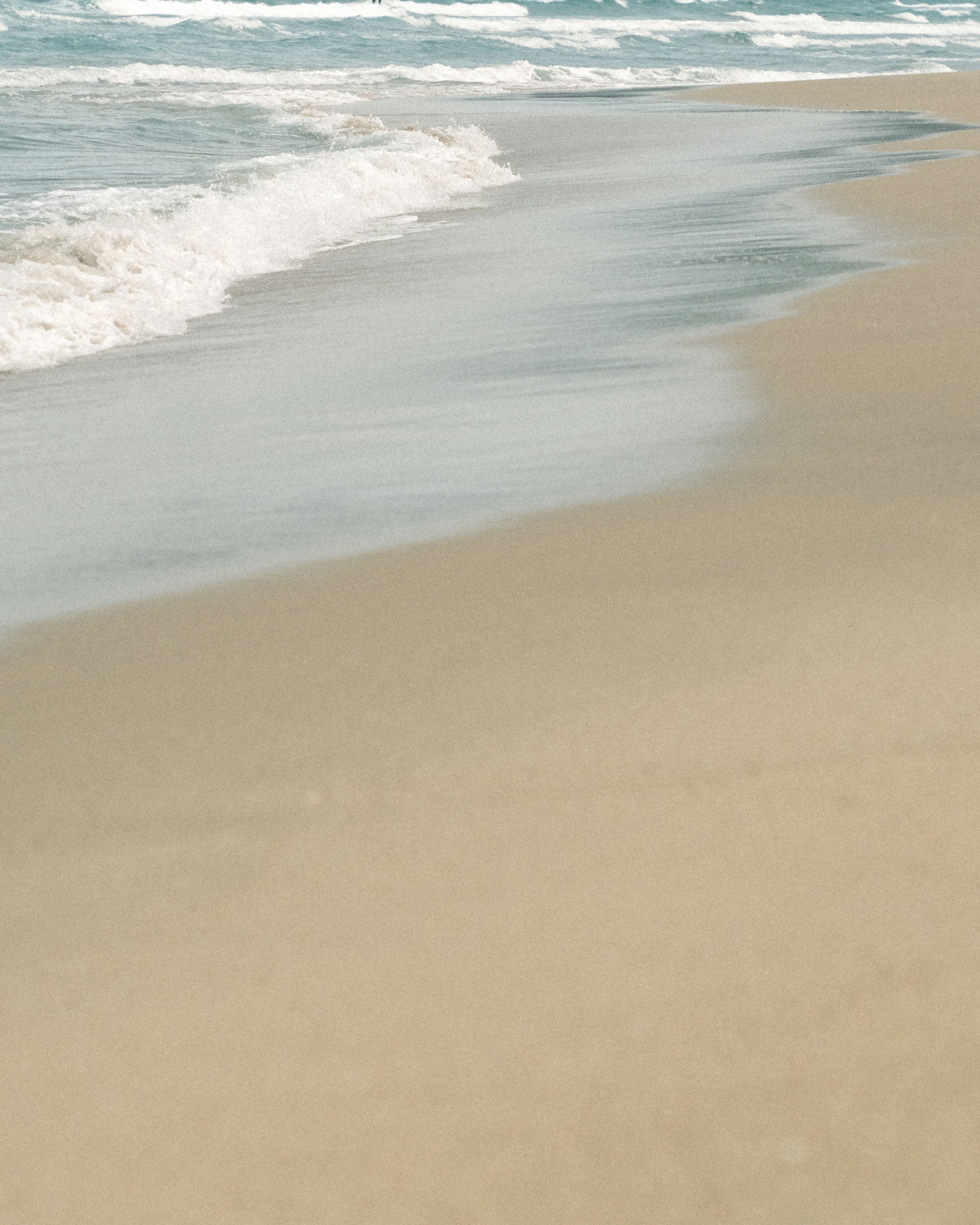 Gentle waves lapping against a sandy beach