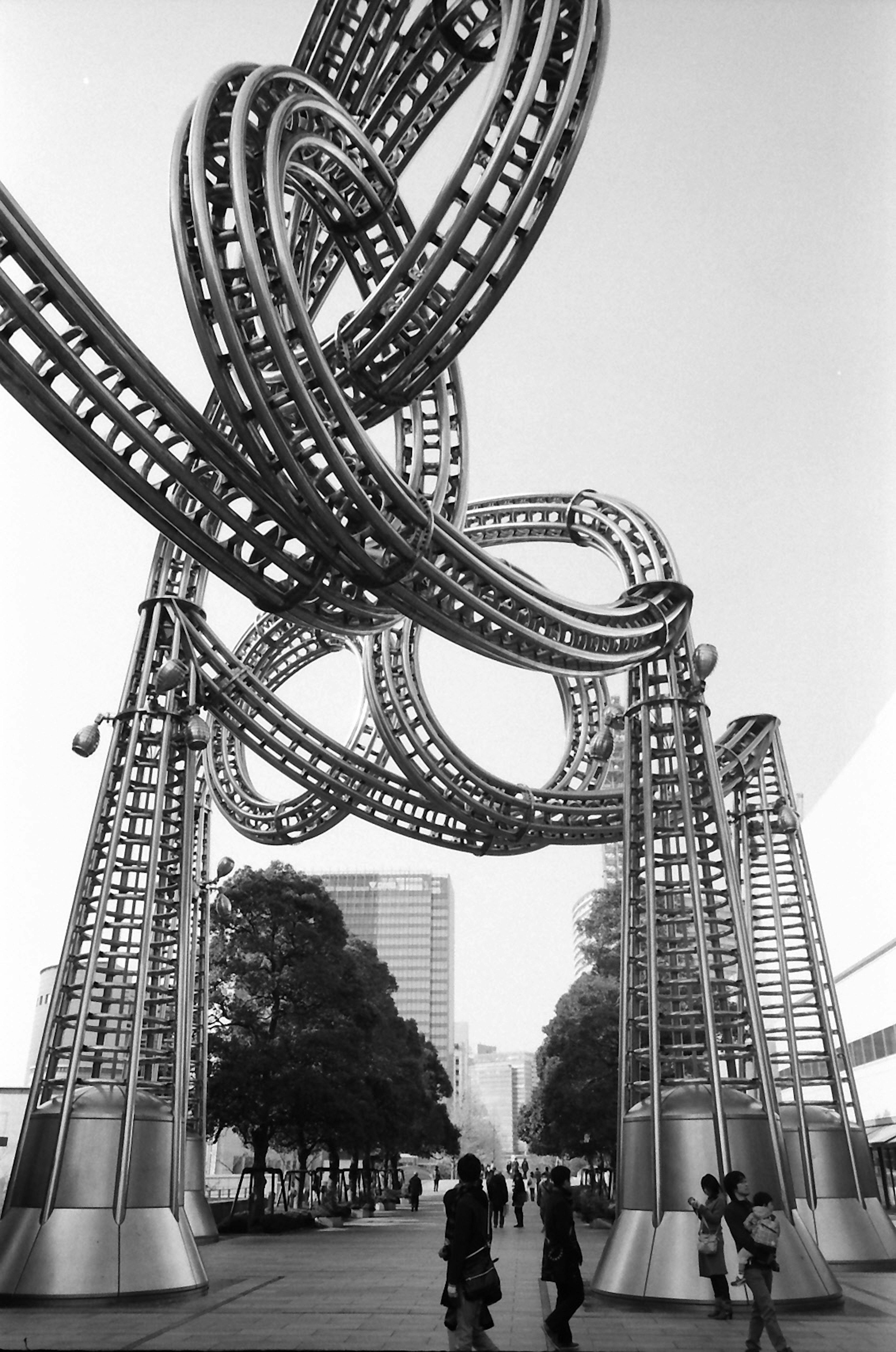 Metal sculpture with intertwined loops and silhouettes of people