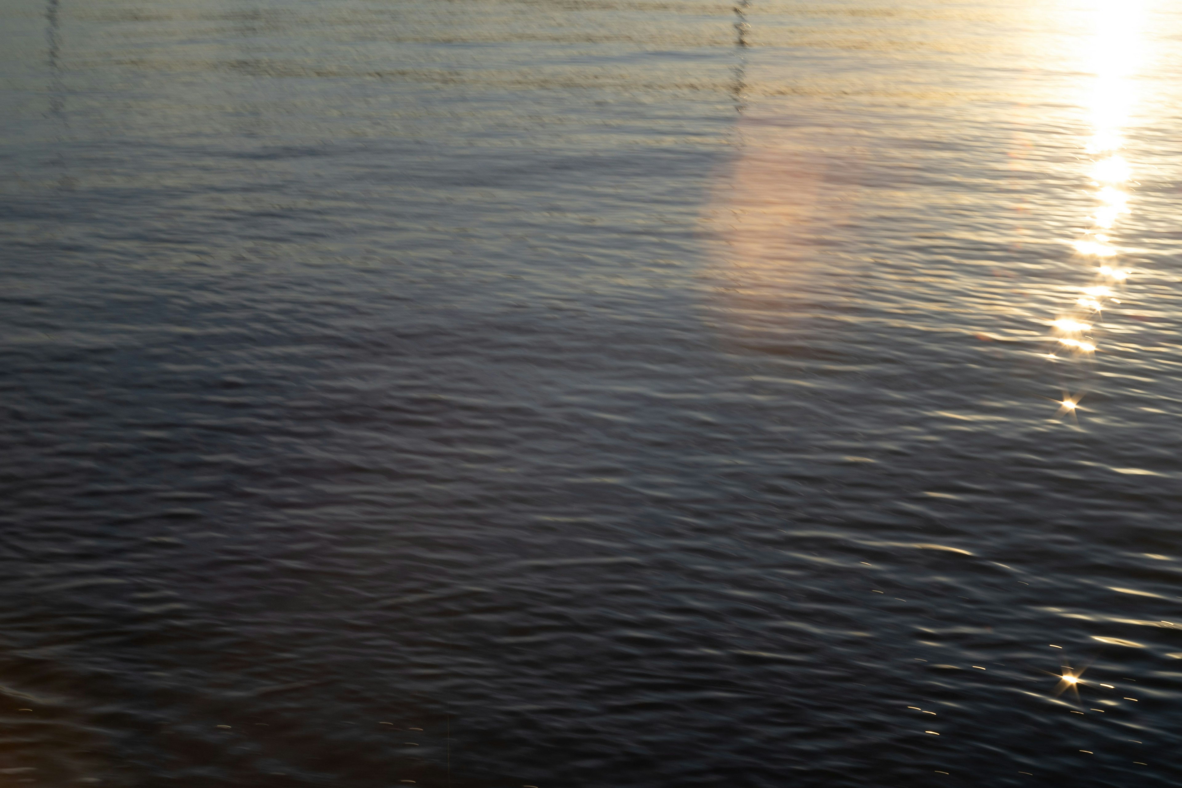 Calm water surface reflecting light