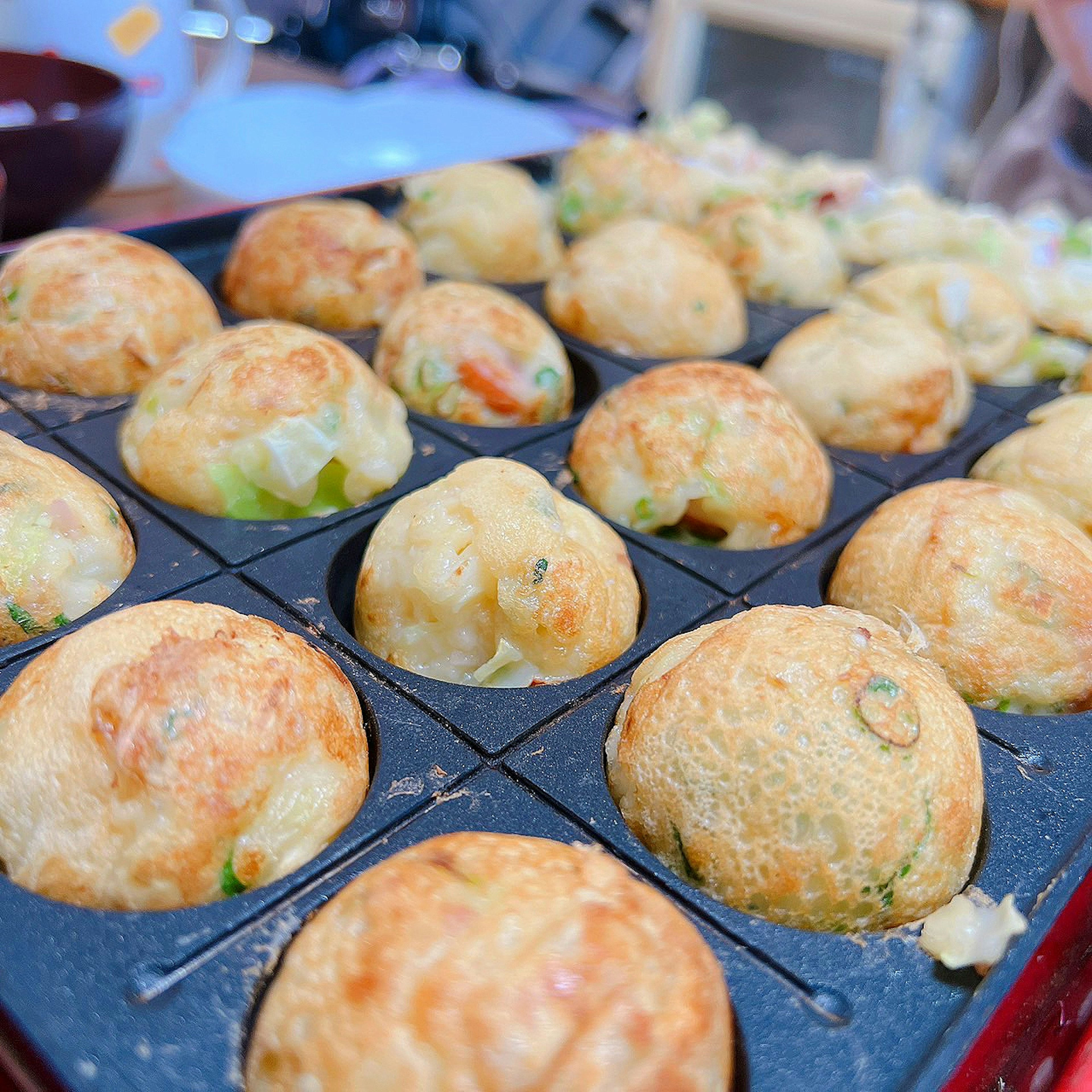 Close-up of takoyaki balls in a cooking tray