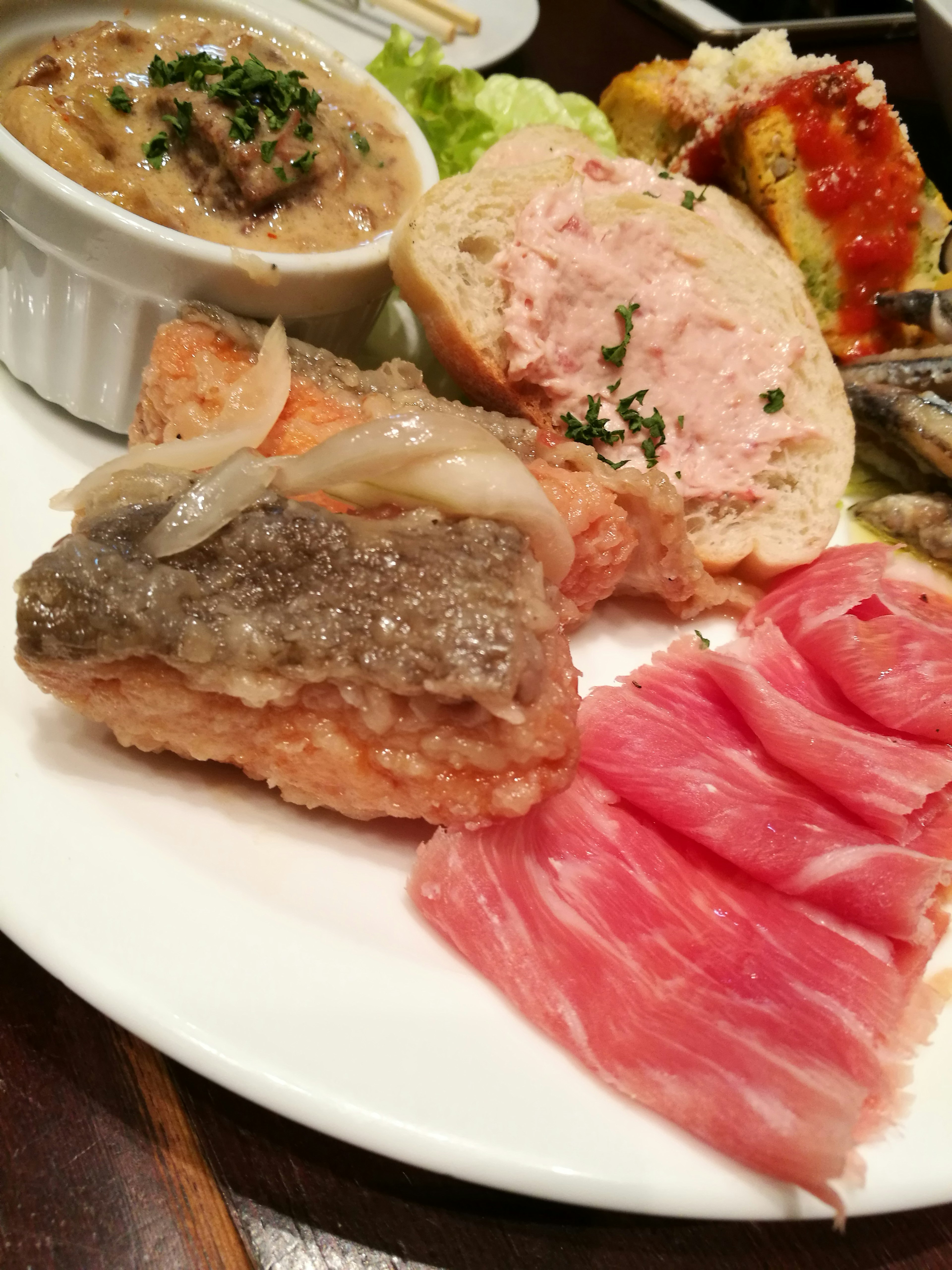 A platter featuring an assortment of various dishes including fish and meats