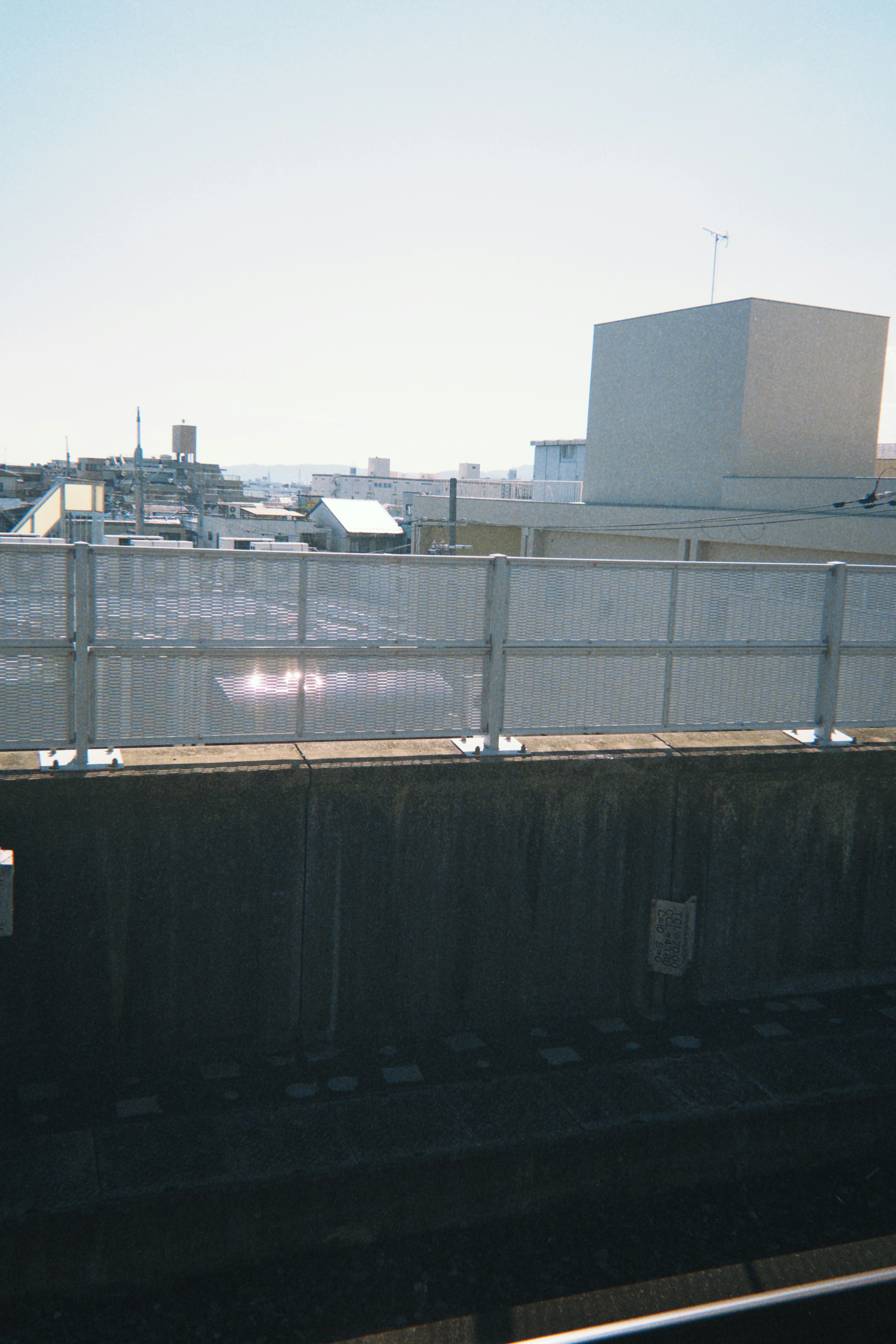 Clear day urban landscape with a fence