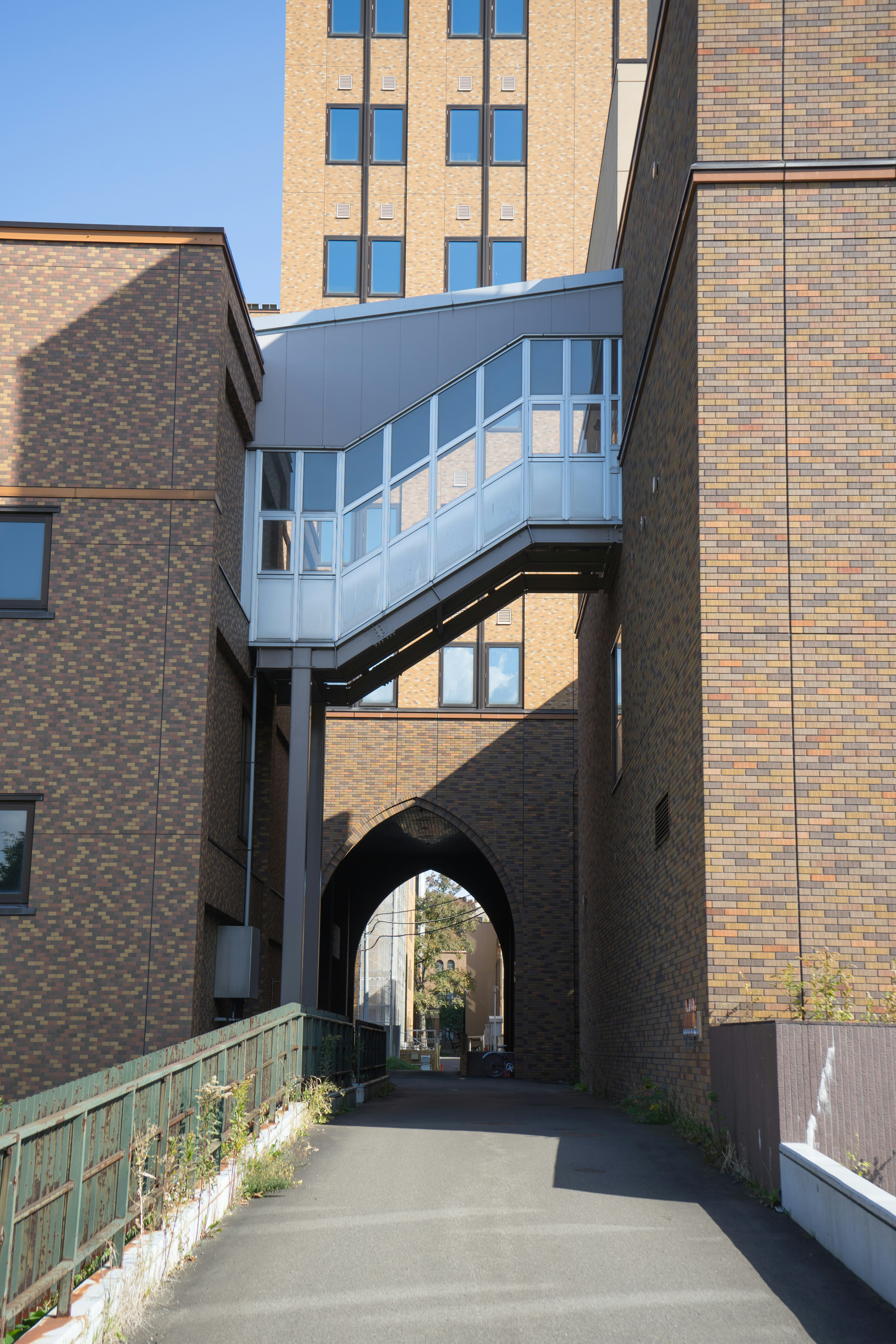 View of brown brick buildings with a glass walkway