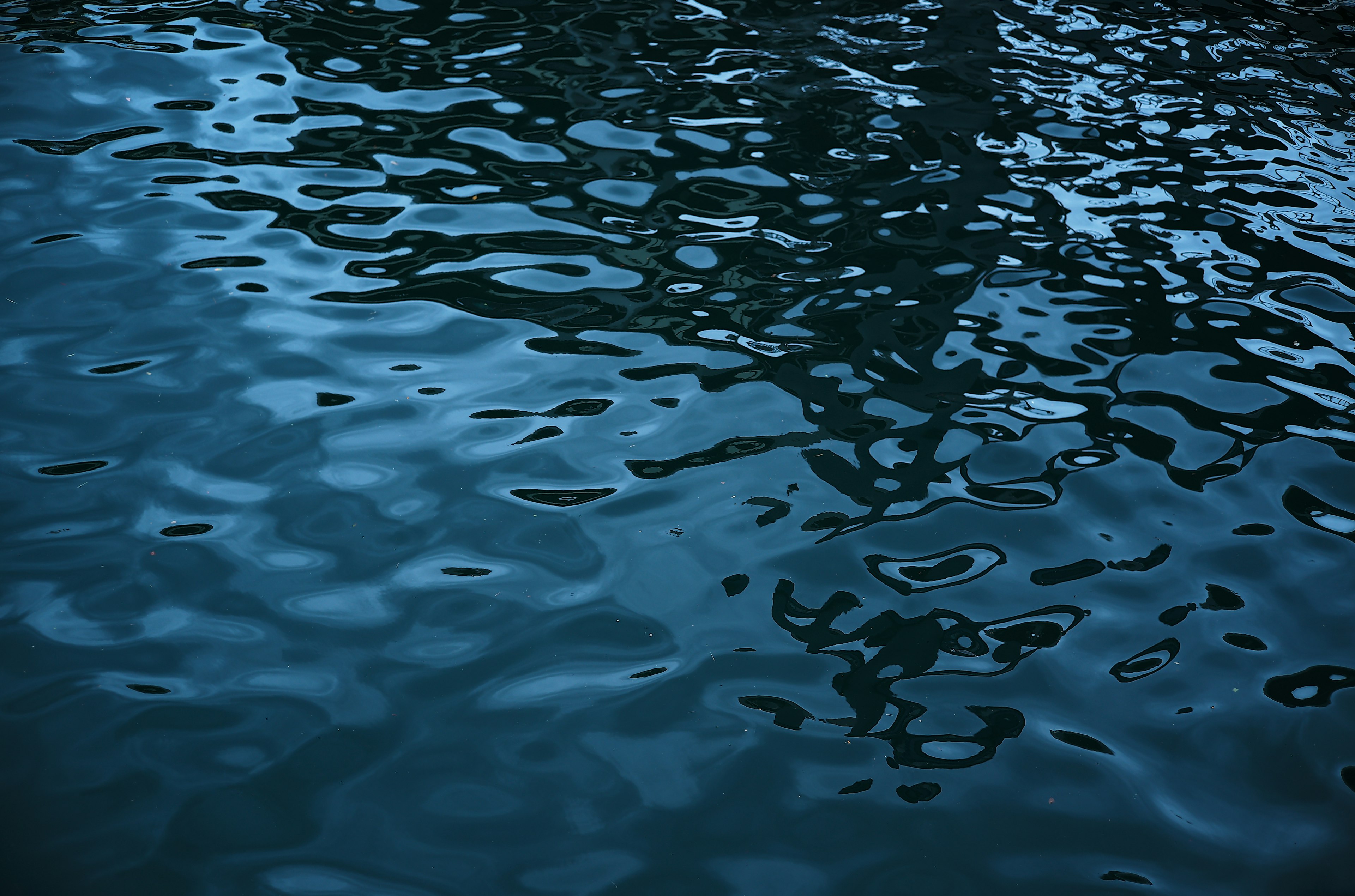 Rippling blue water surface with reflections