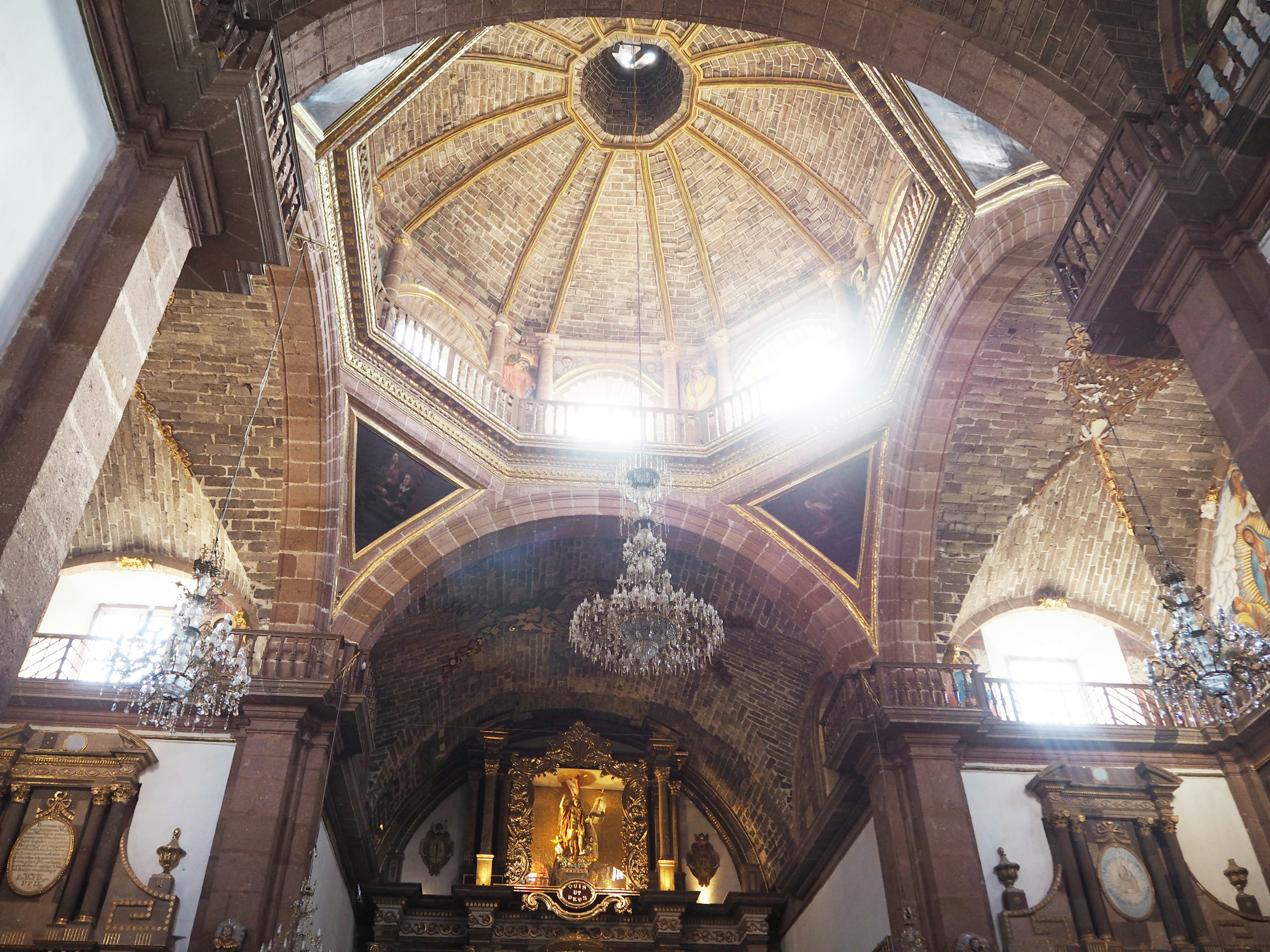 Interior of a church featuring a beautiful ceiling and chandelier