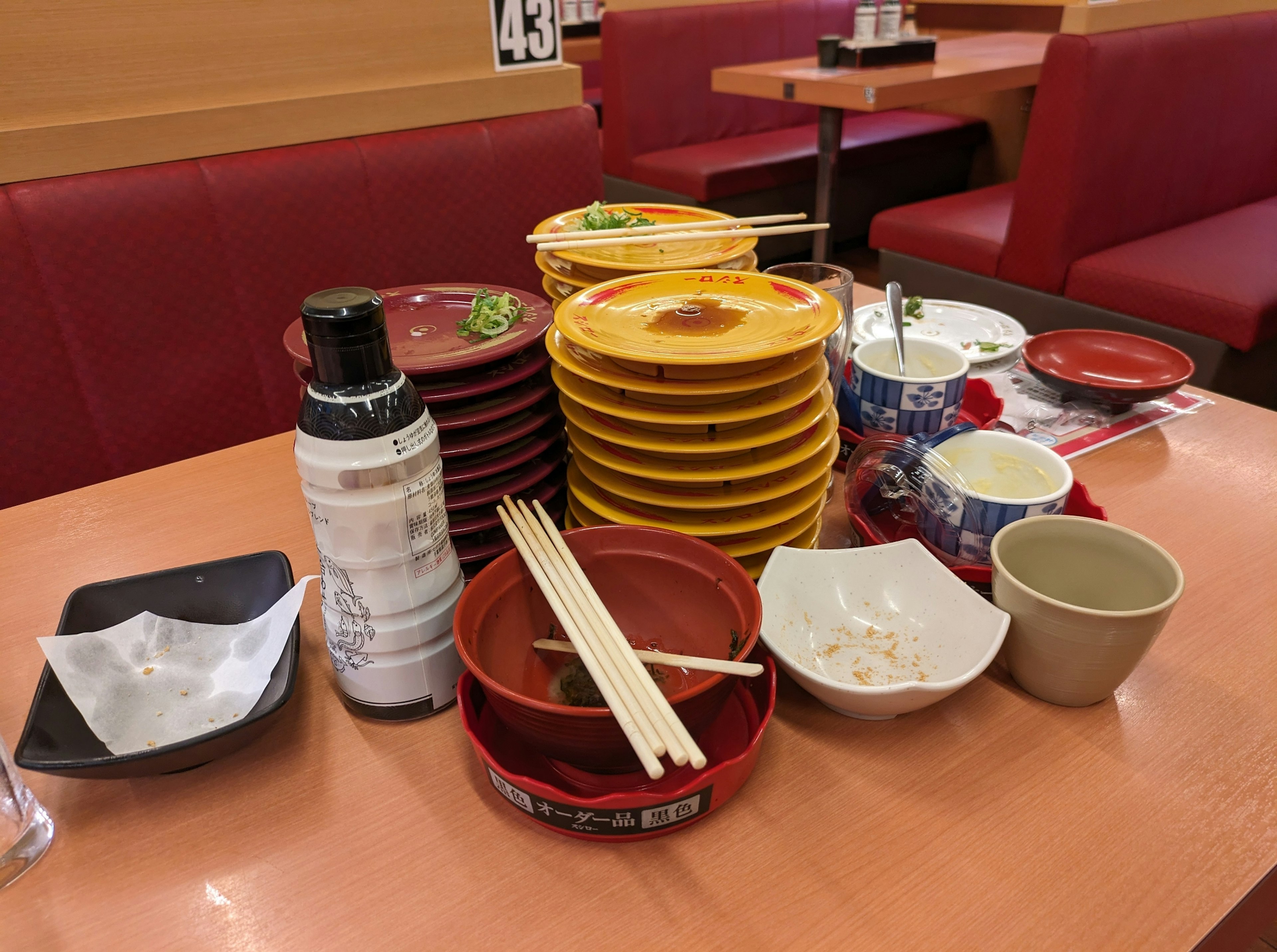 Table with stacked empty plates and chopsticks