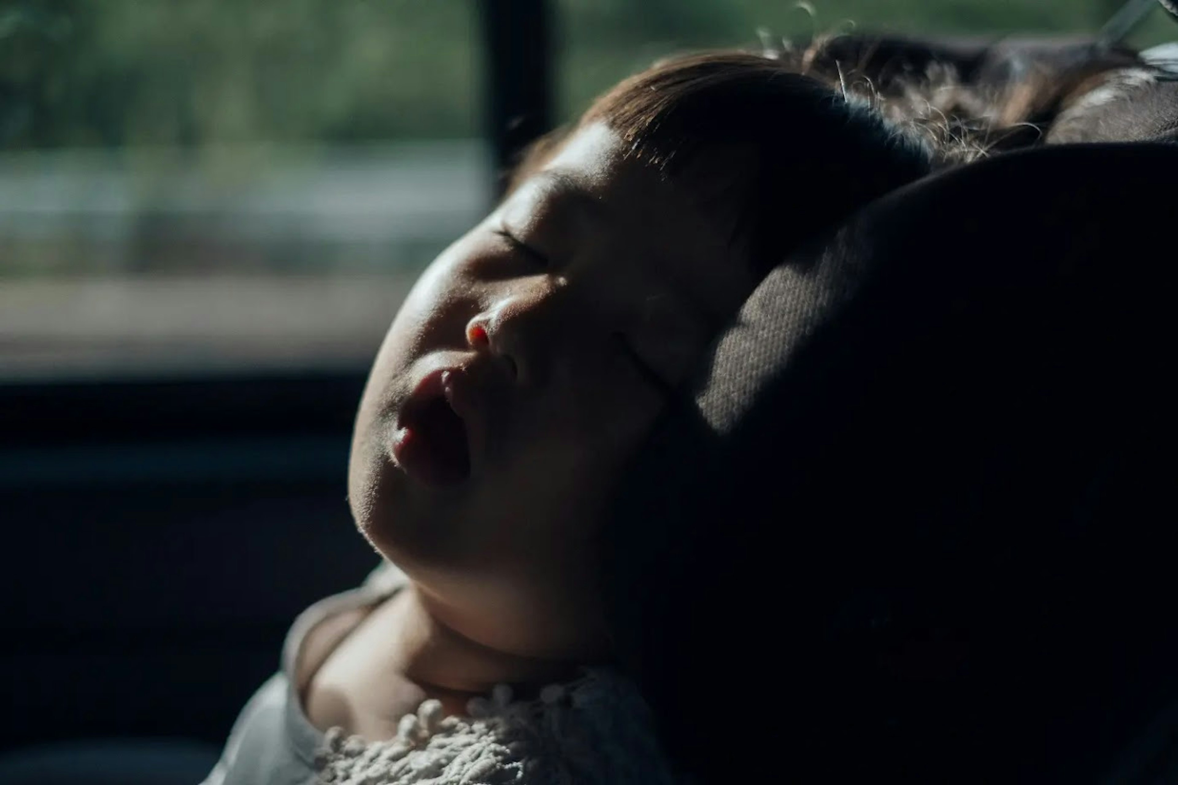 Bambino che dorme in auto con un'espressione serena