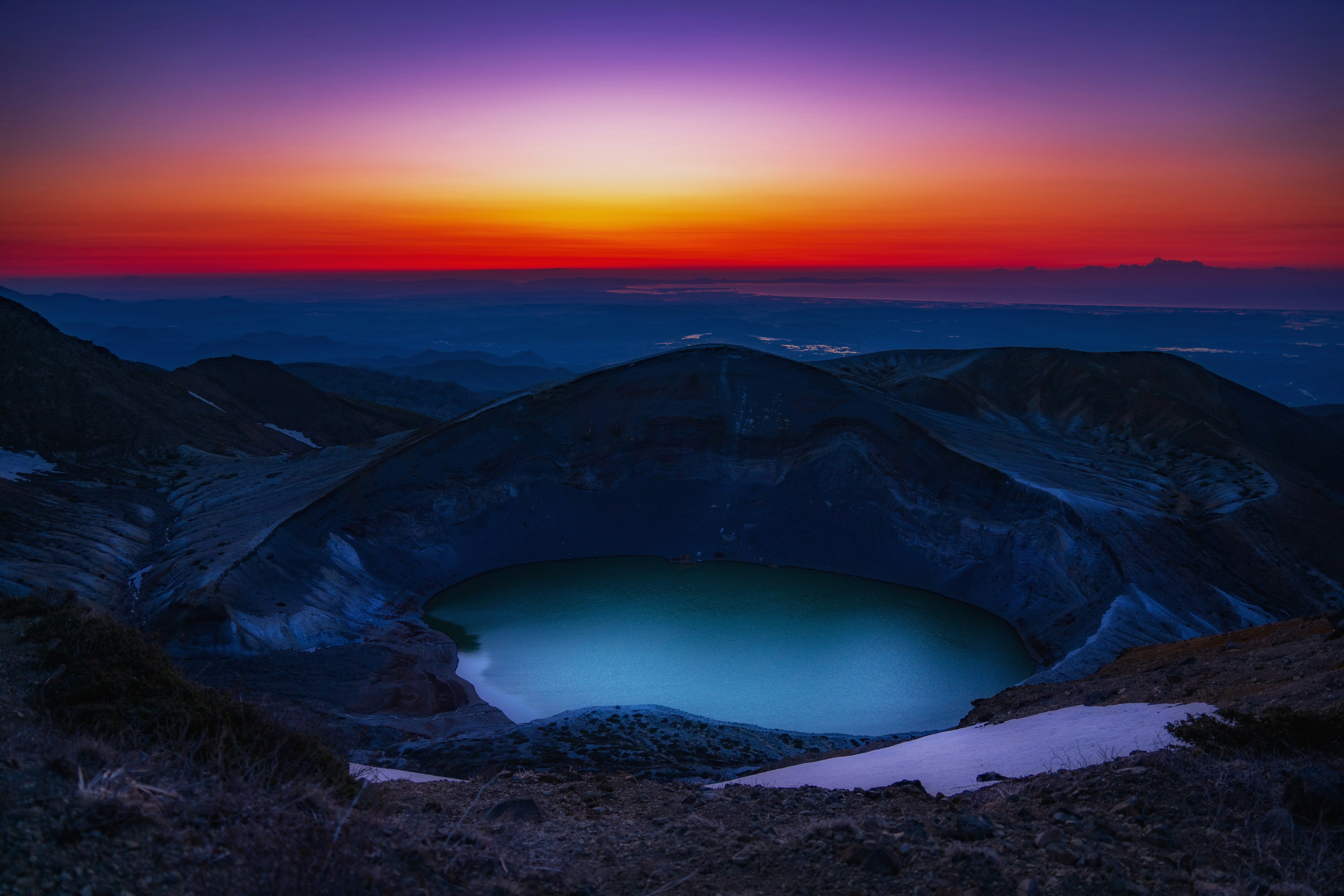 Stunning sunset landscape featuring a volcanic crater and tranquil lake