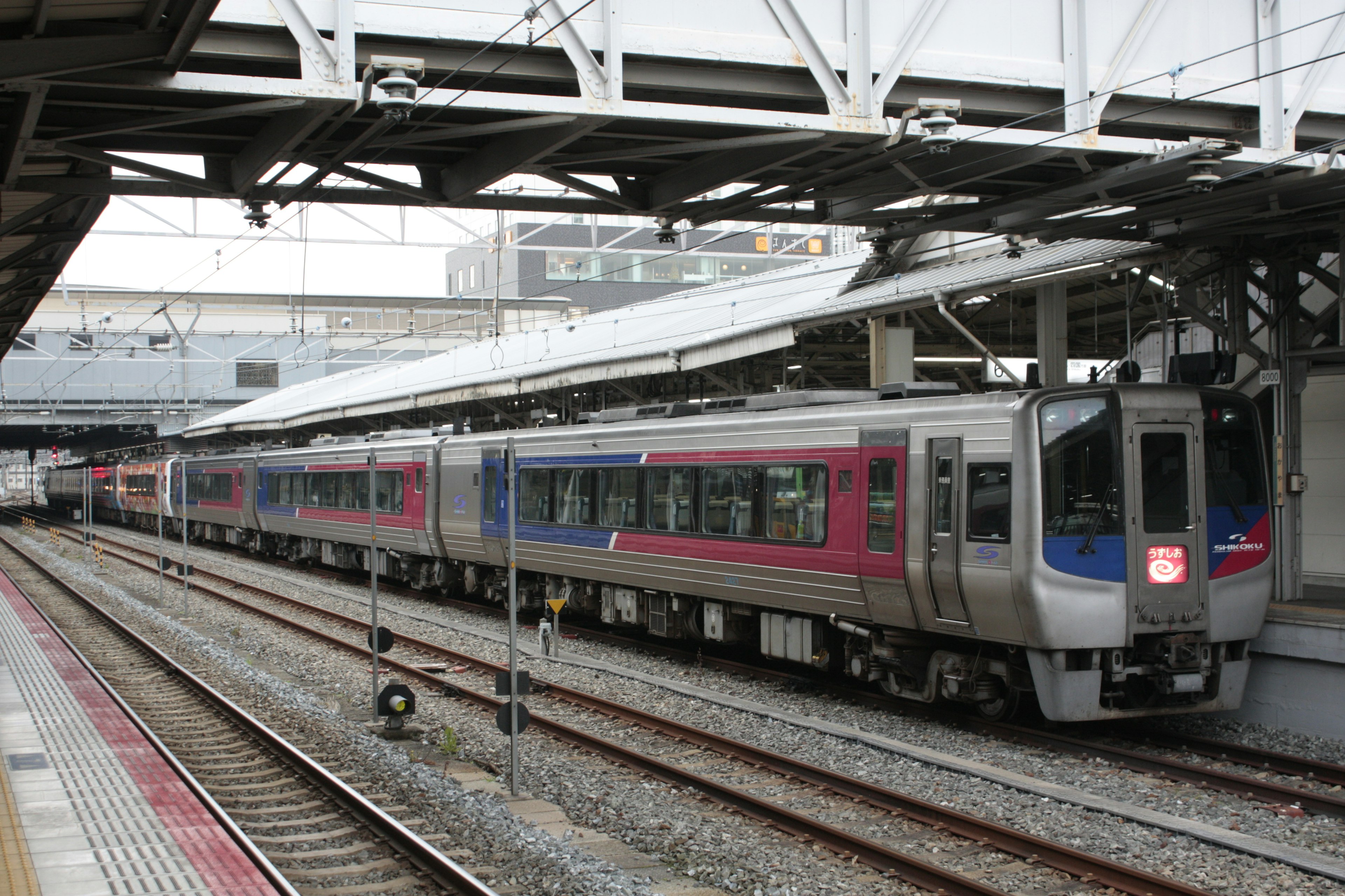 A train at a modern station with tracks and platforms