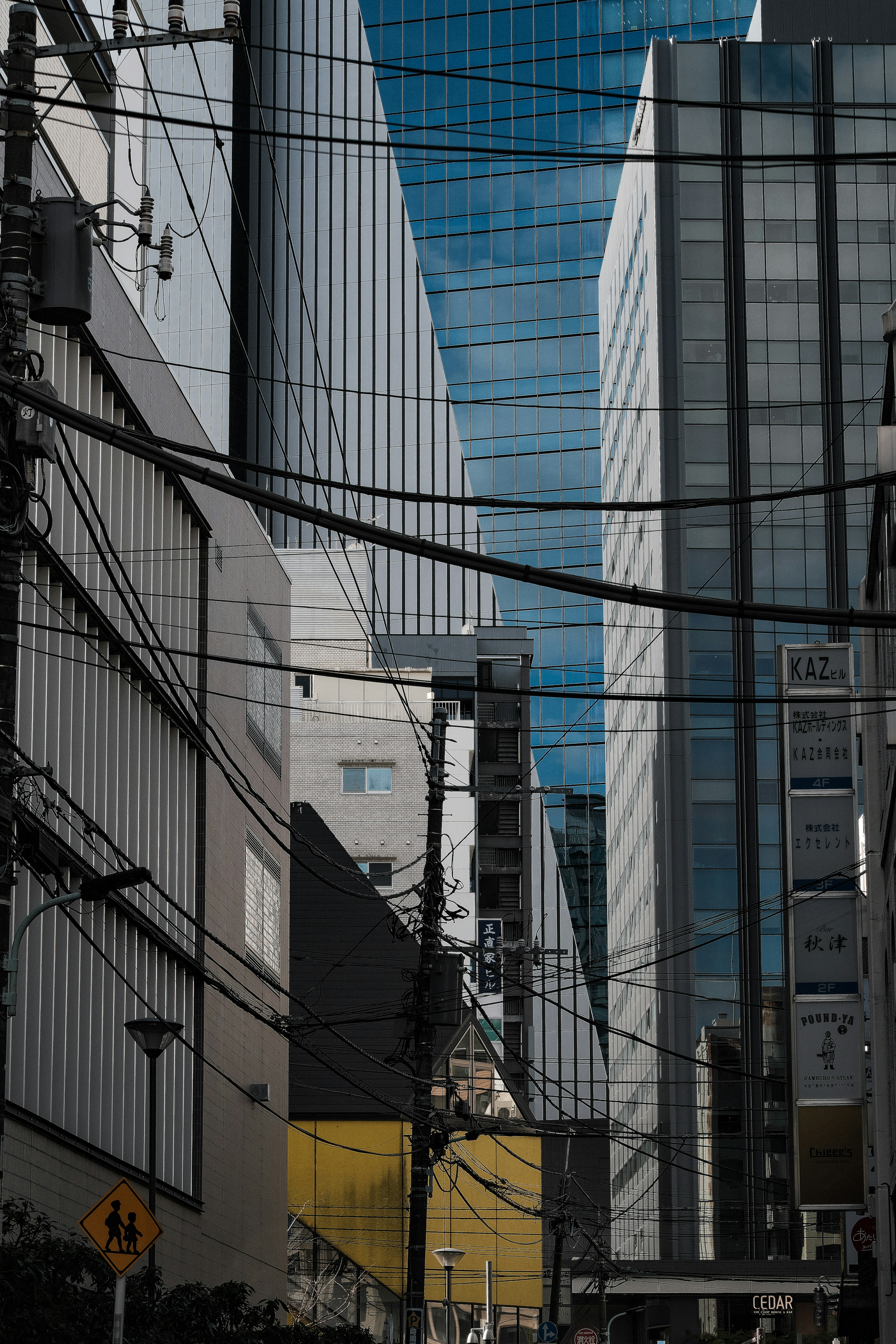 Urban landscape featuring intersecting skyscrapers and power lines