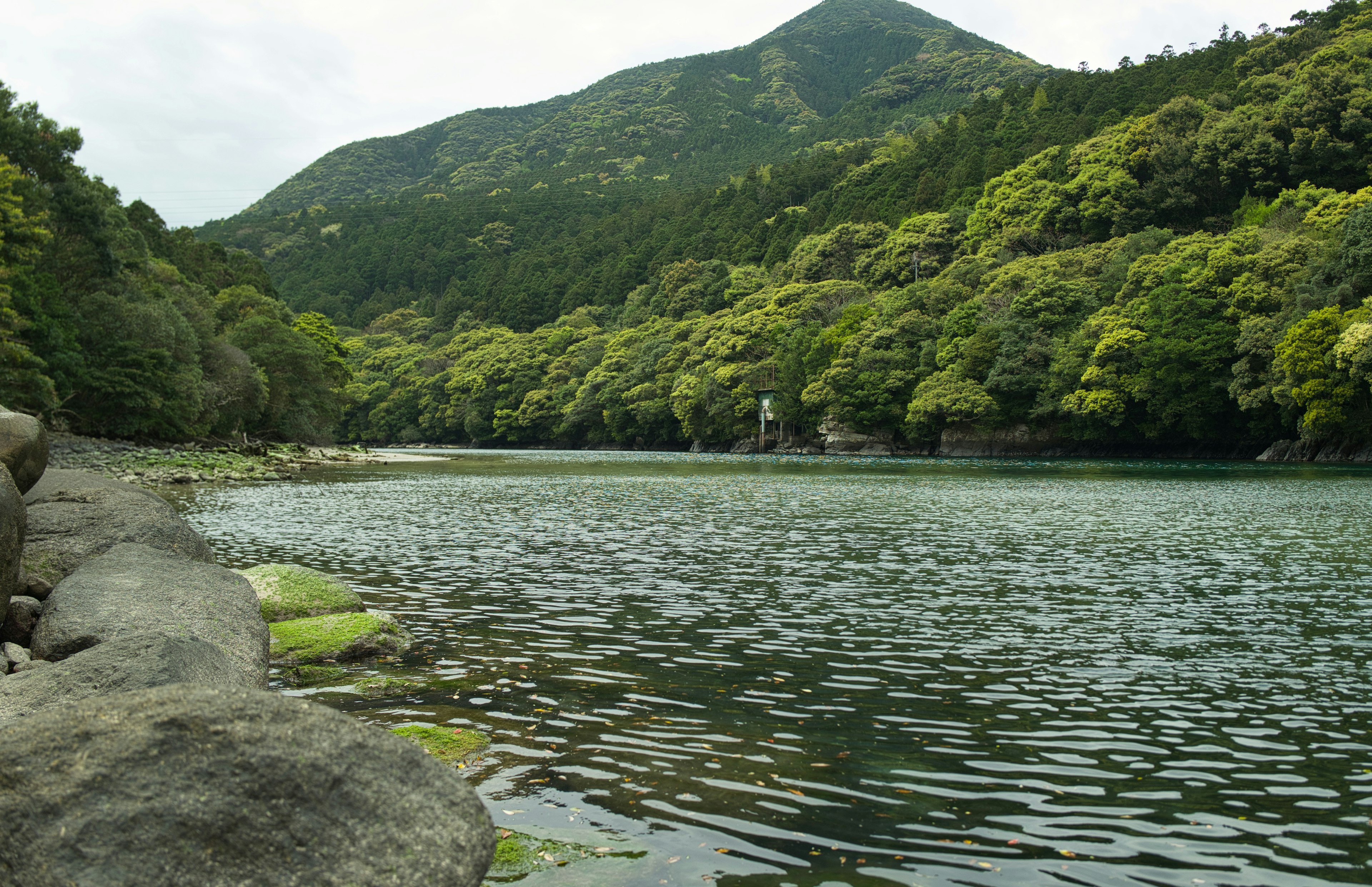 Ruhige Flusslandschaft mit üppigen grünen Bergen