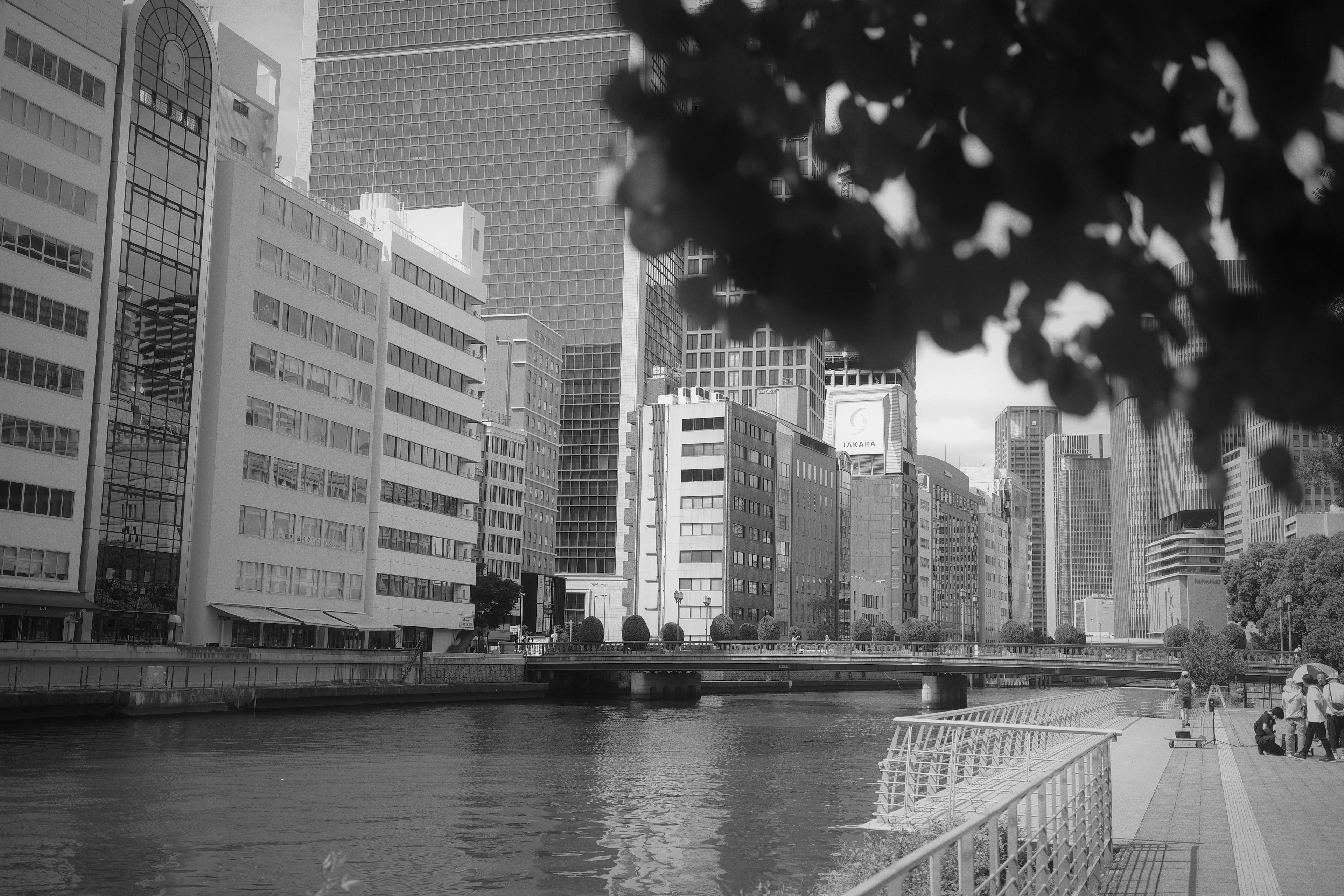 Modern buildings along a riverside walkway