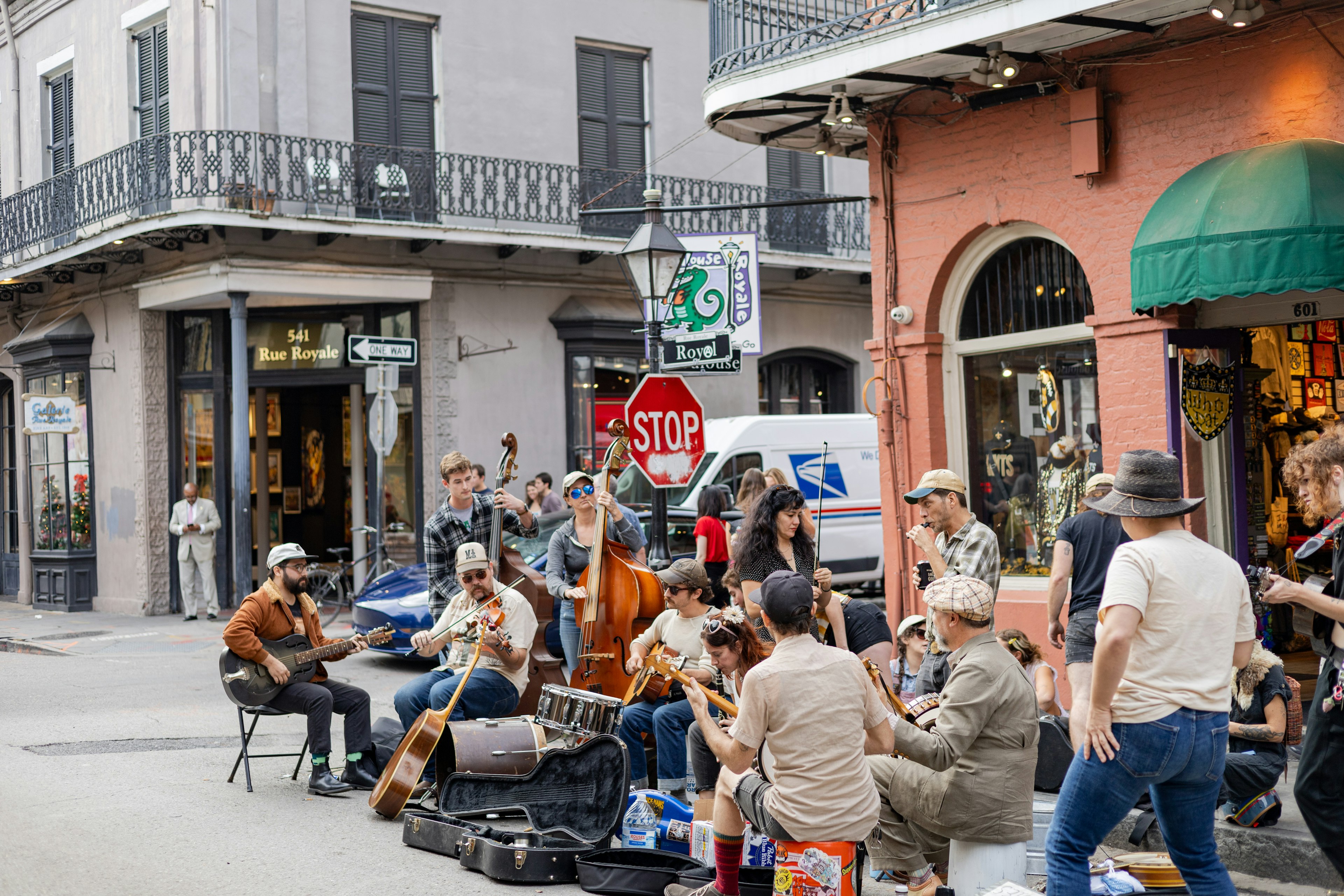 A lively scene of musicians performing on the street with an audience gathered around