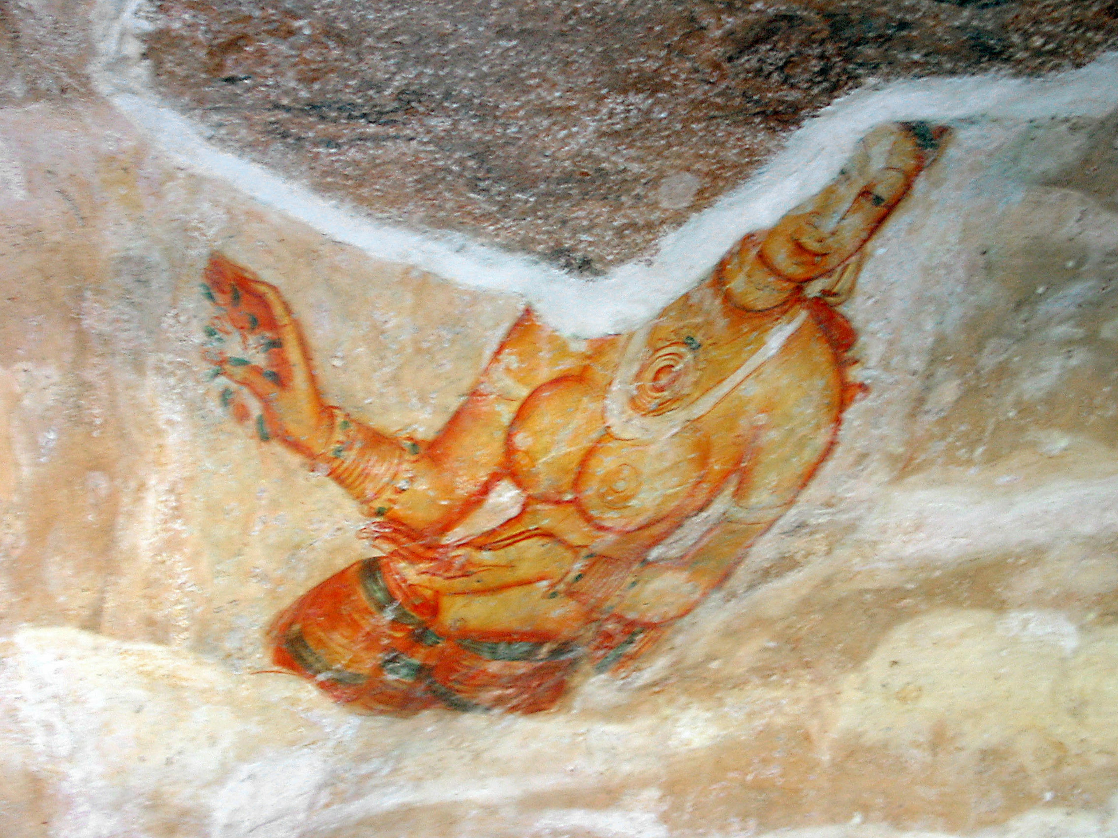 Cave painting of a seated deity with intricate details