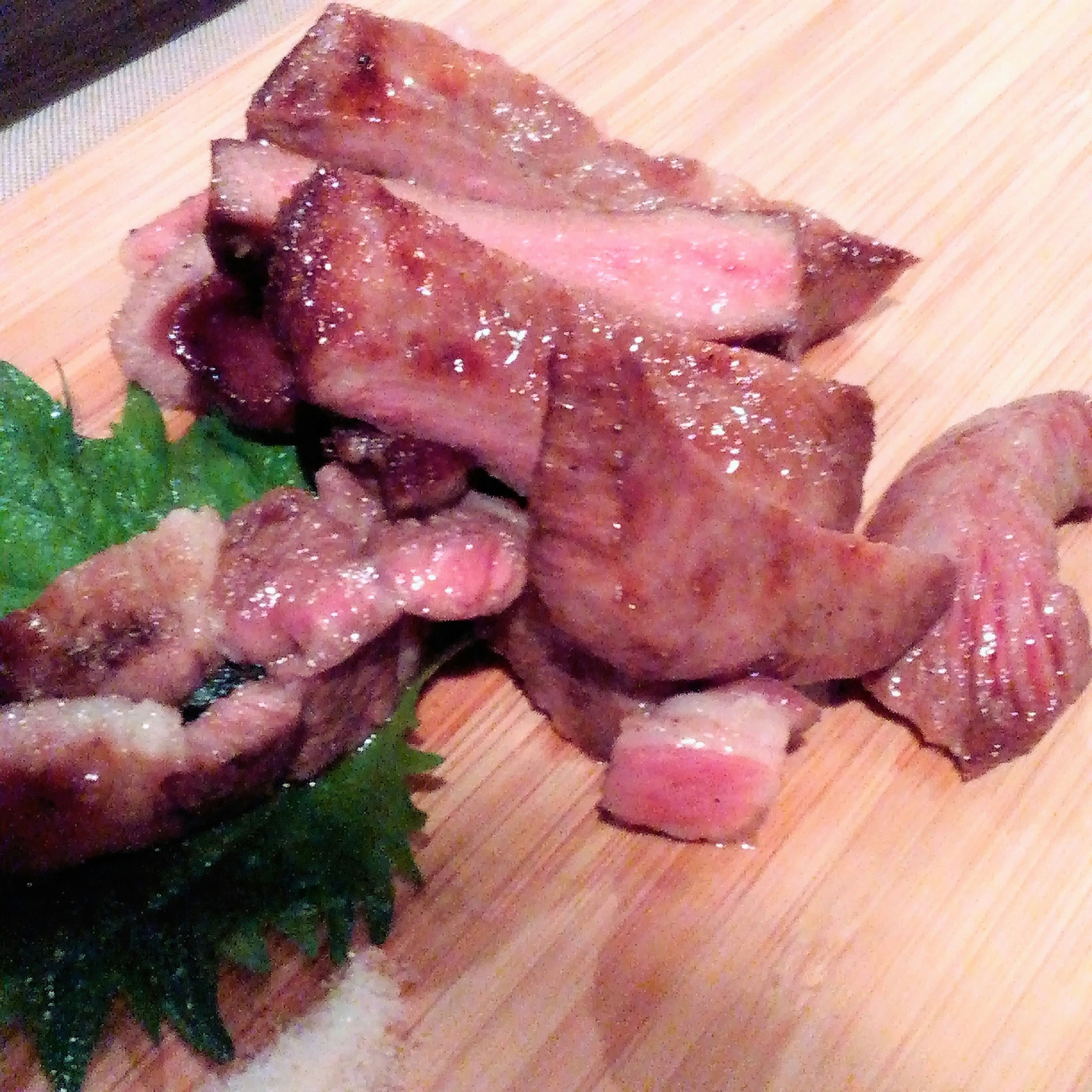 Grilled meat assortment placed on a wooden board