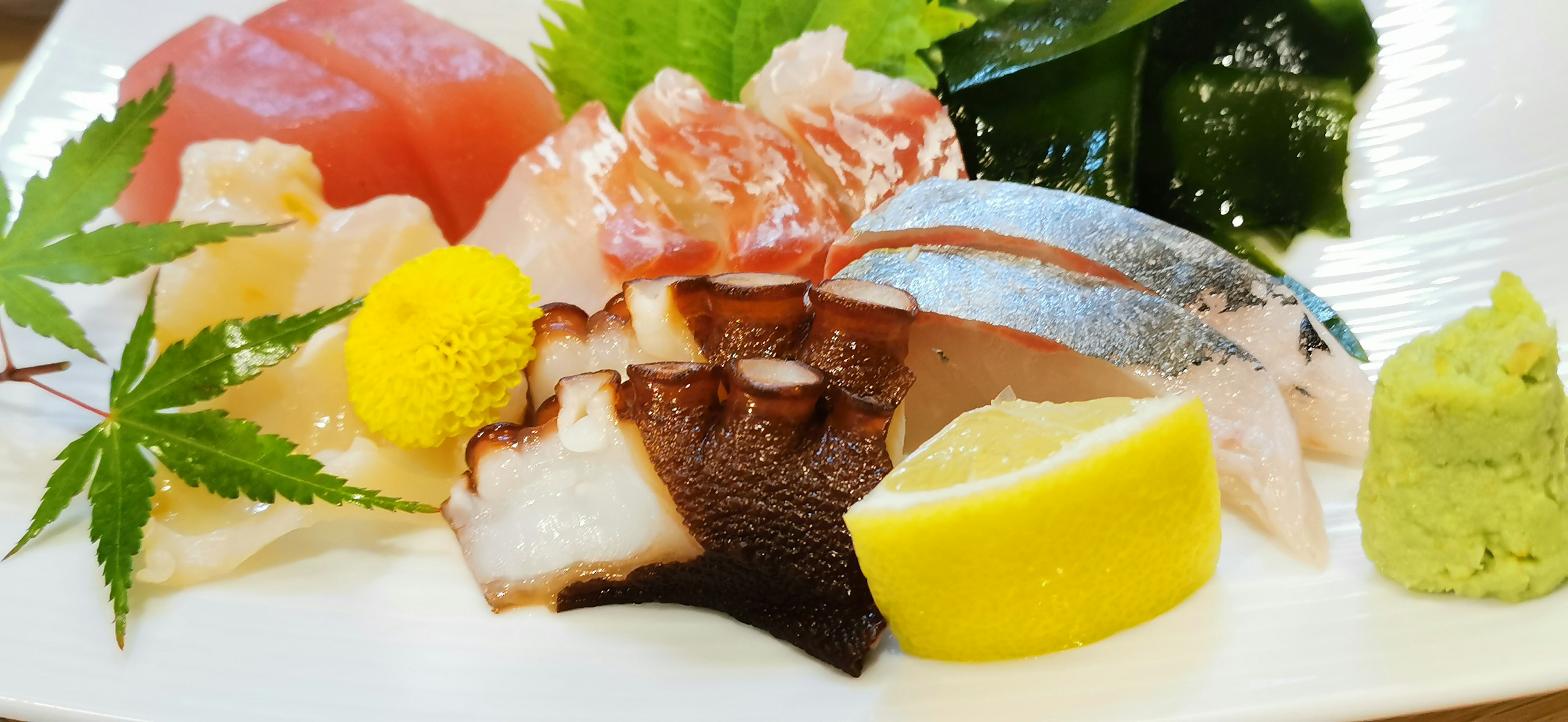 Fresh sushi platter featuring various fish and garnishes