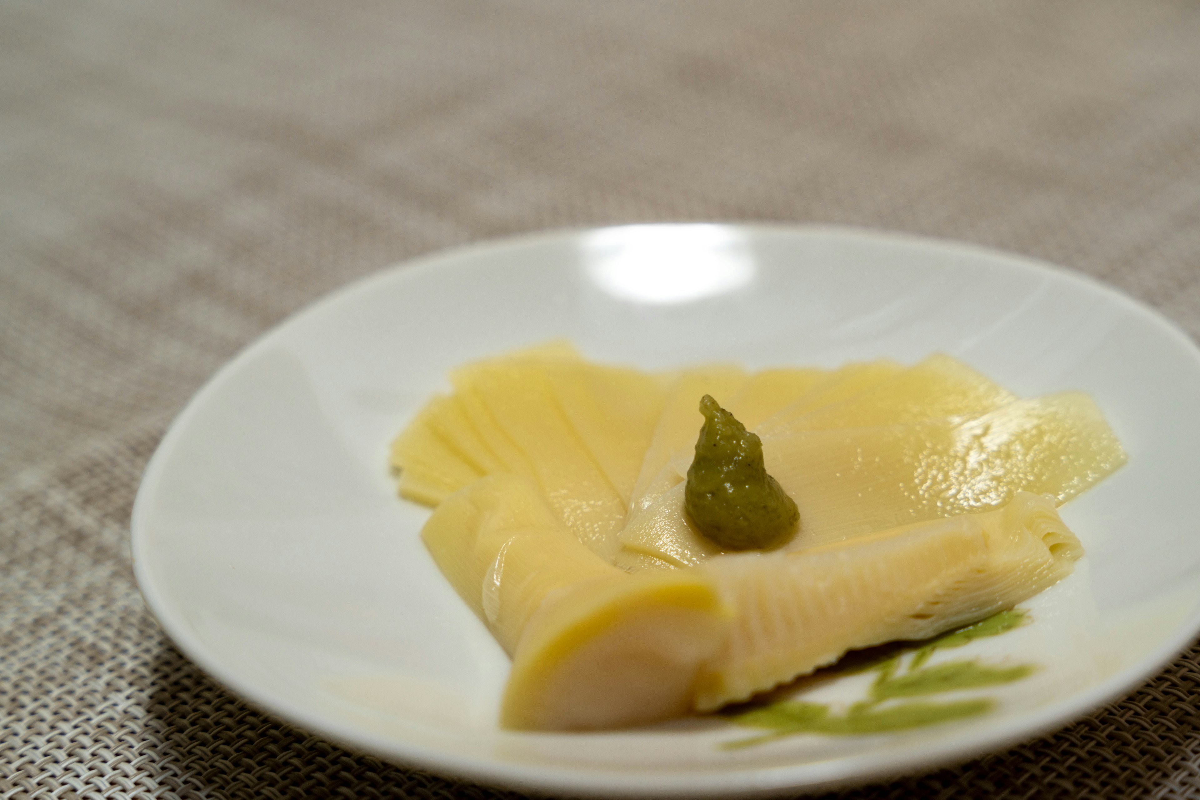 Sliced bamboo shoots with wasabi on a plate