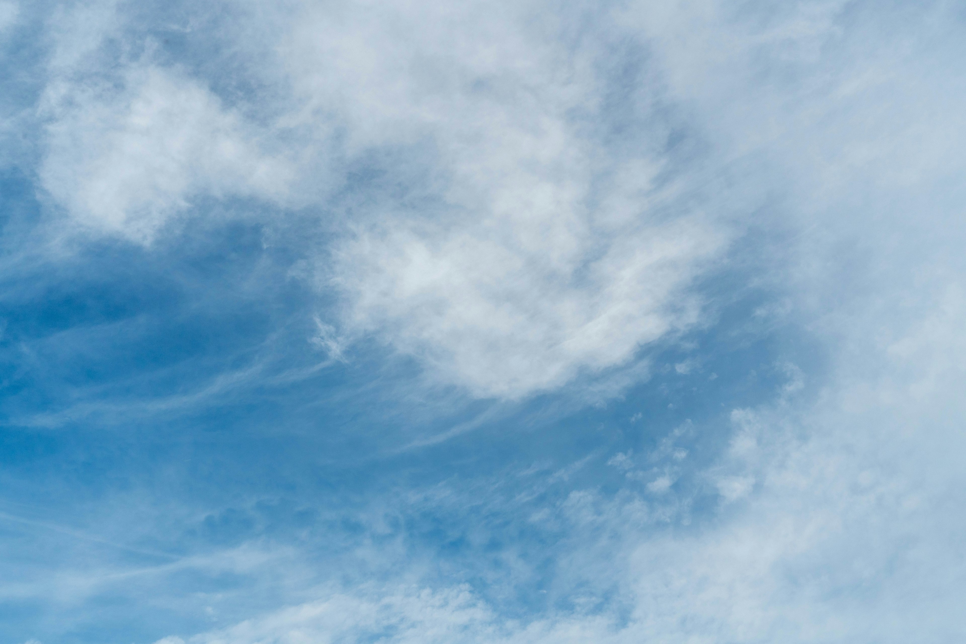 Thin clouds in a bright blue sky