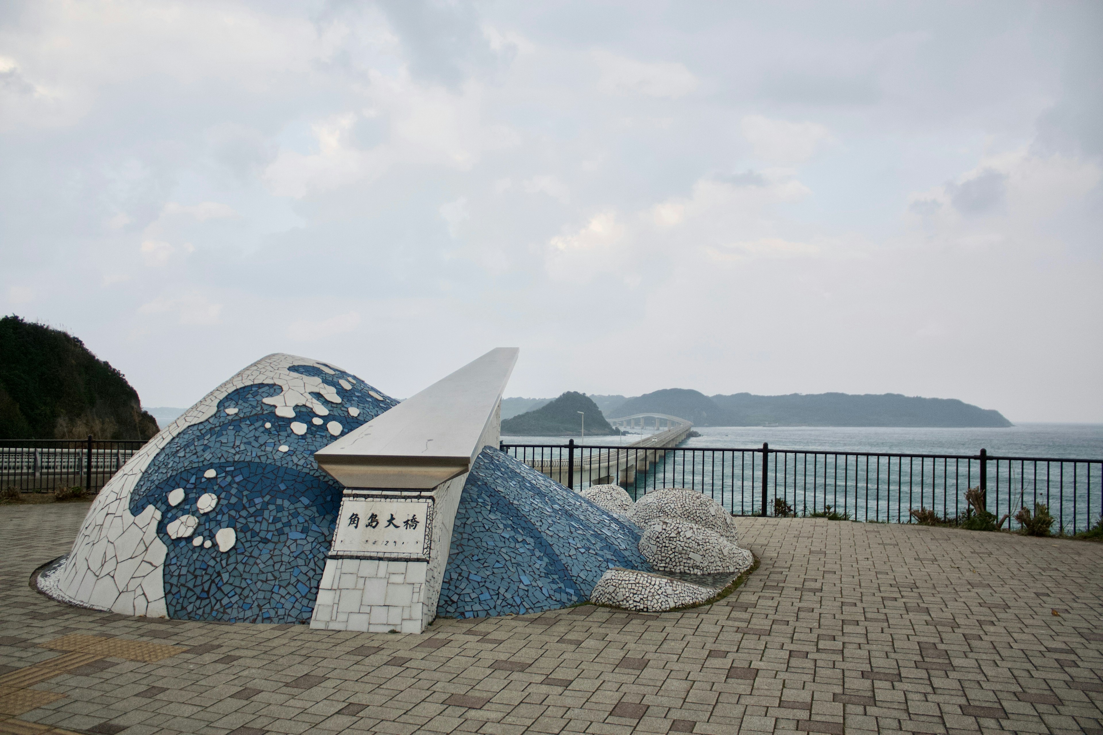 Mosaic art sculpture of a fish inspired by the sea with a beautiful landscape