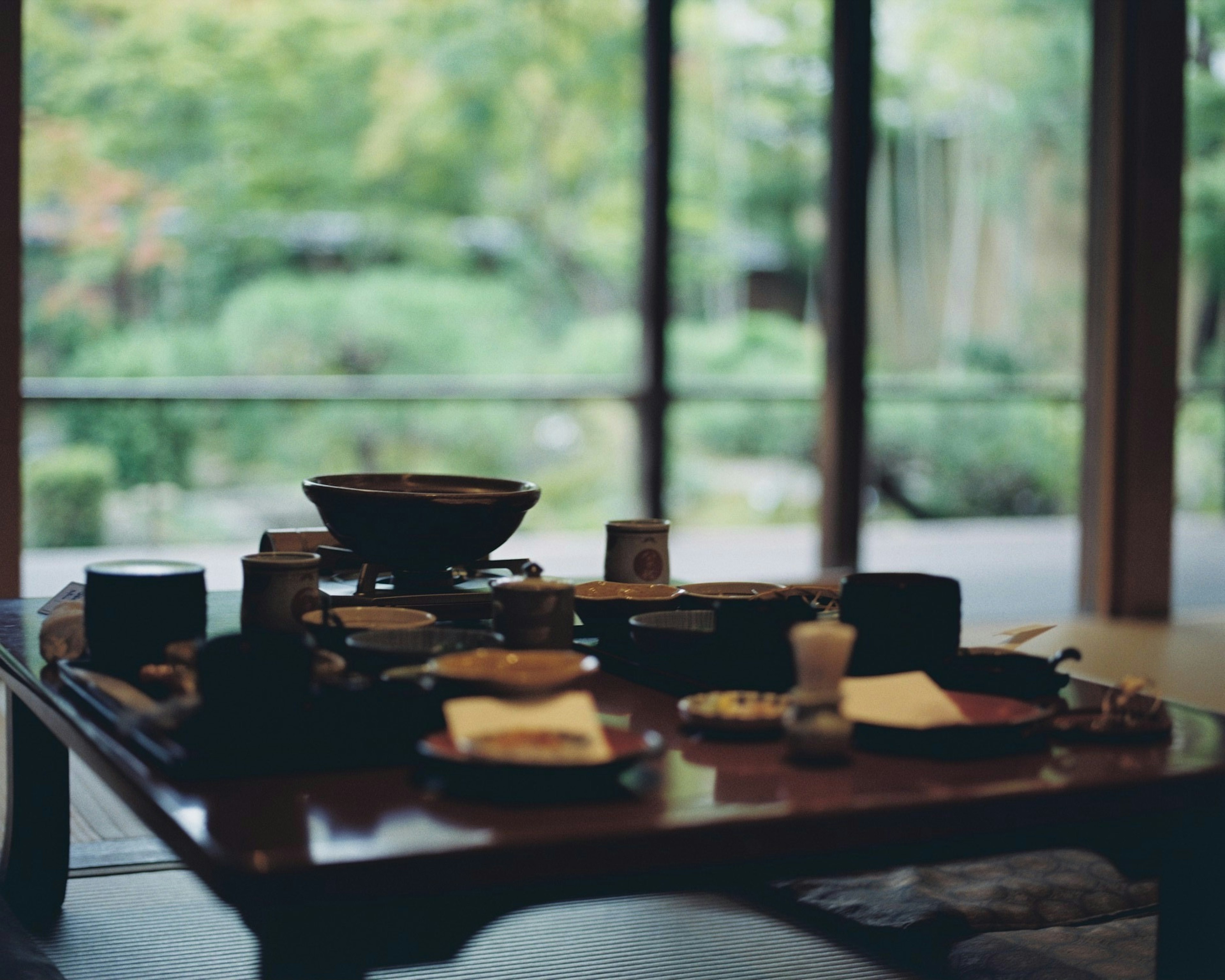 Configuración de mesa de comedor japonesa con vista a un hermoso jardín