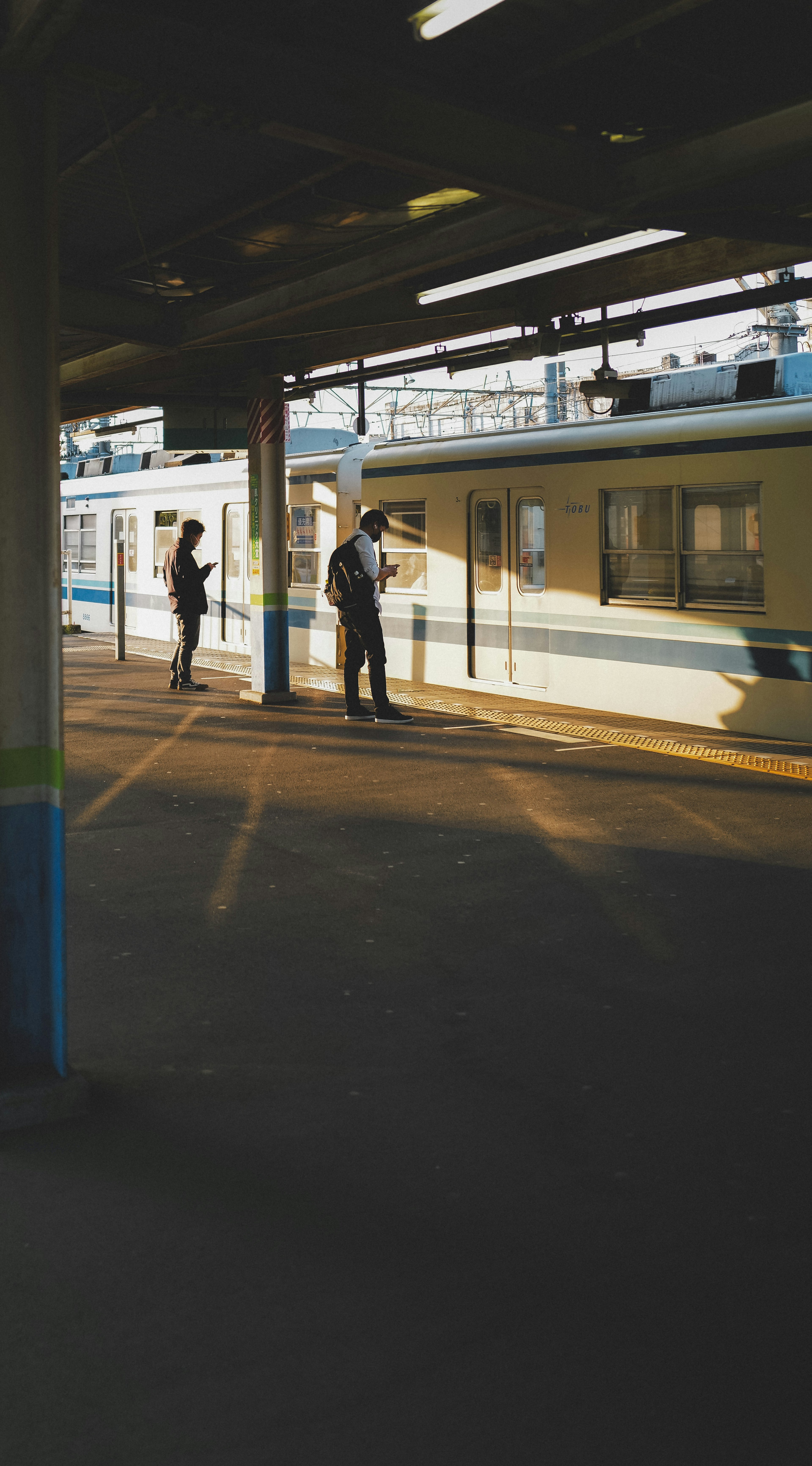 People waiting on a train platform with a train