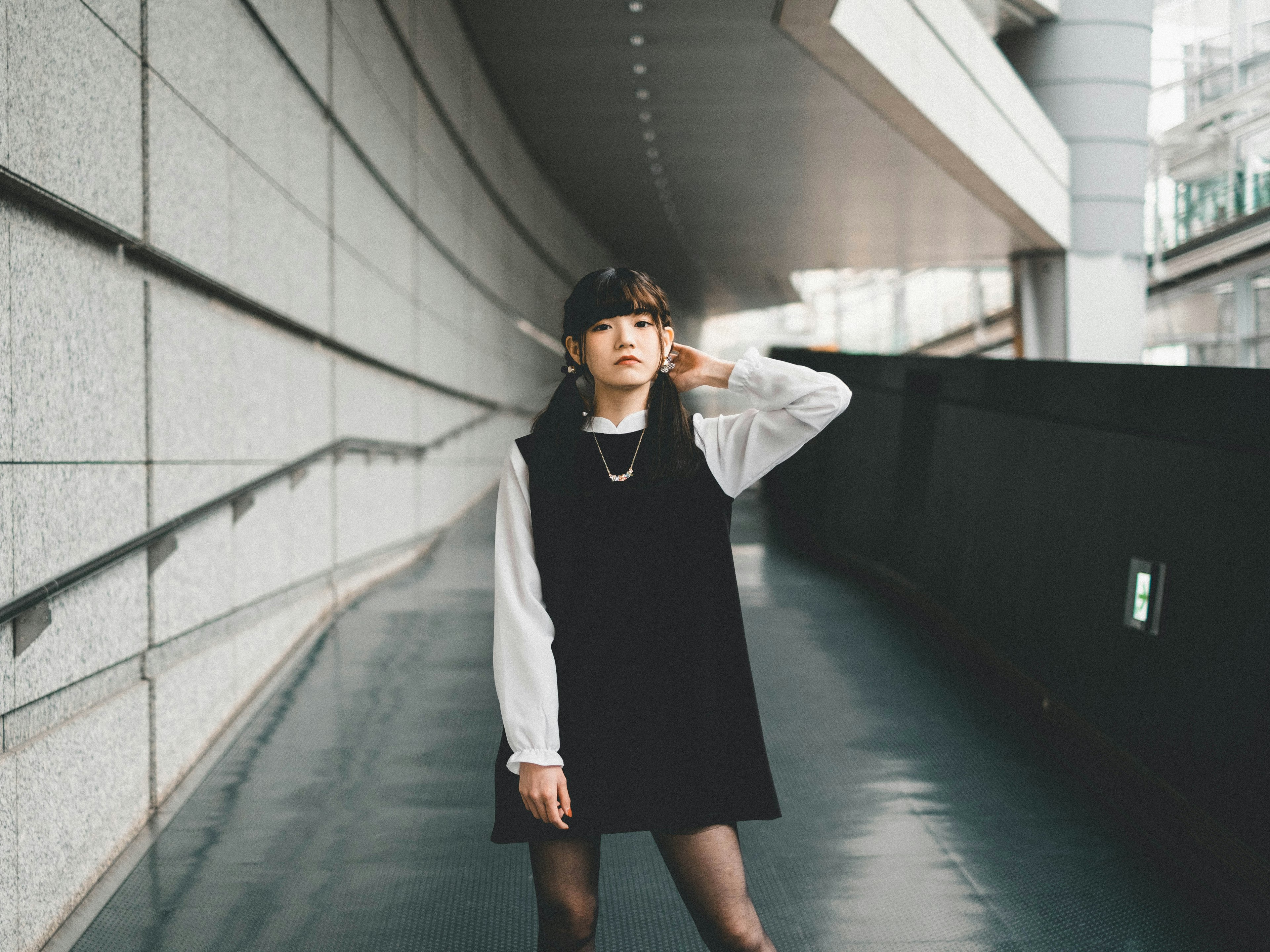 A woman wearing a black dress in an urban setting