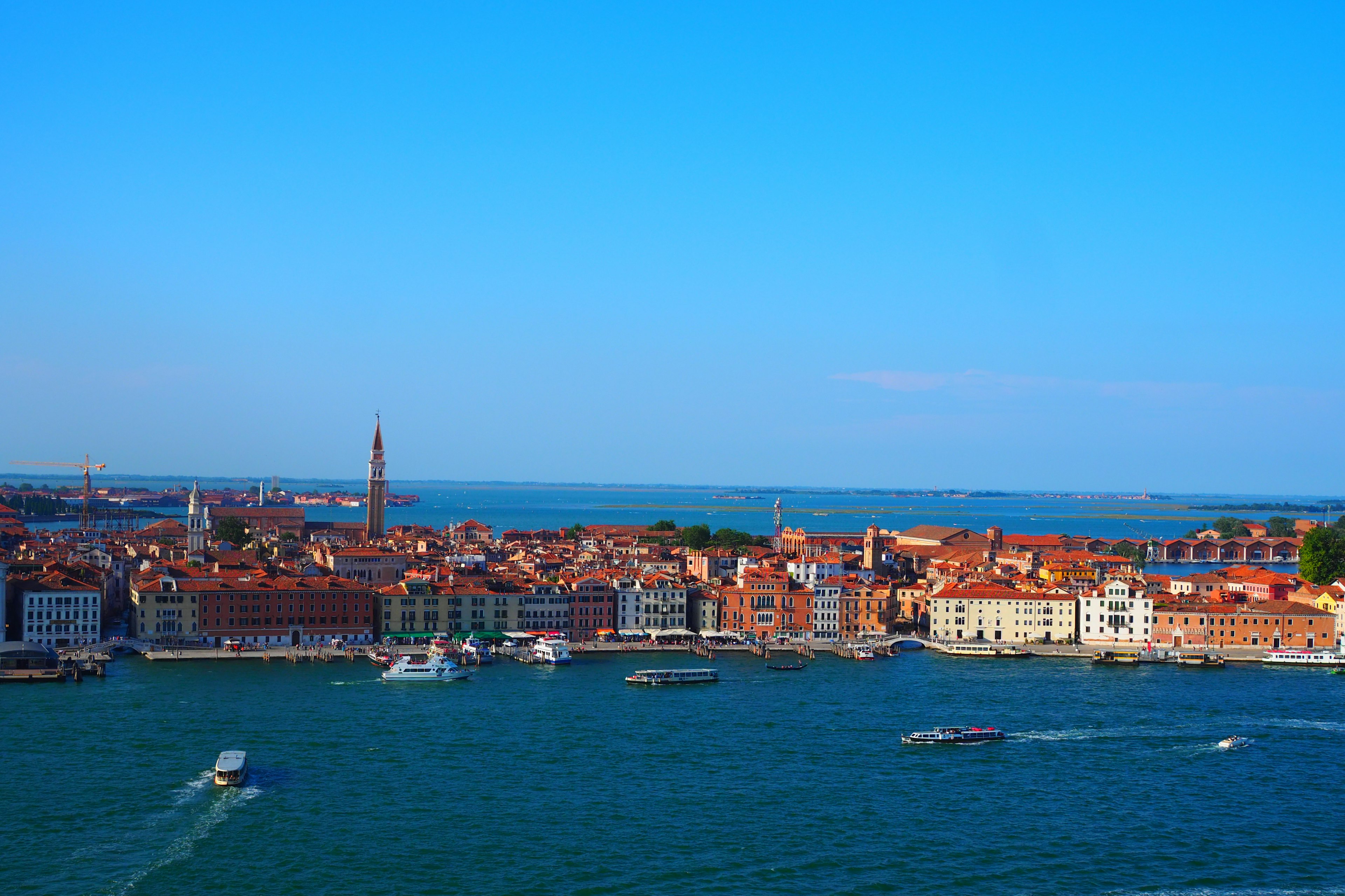 Venetian coastline with colorful buildings under a clear blue sky