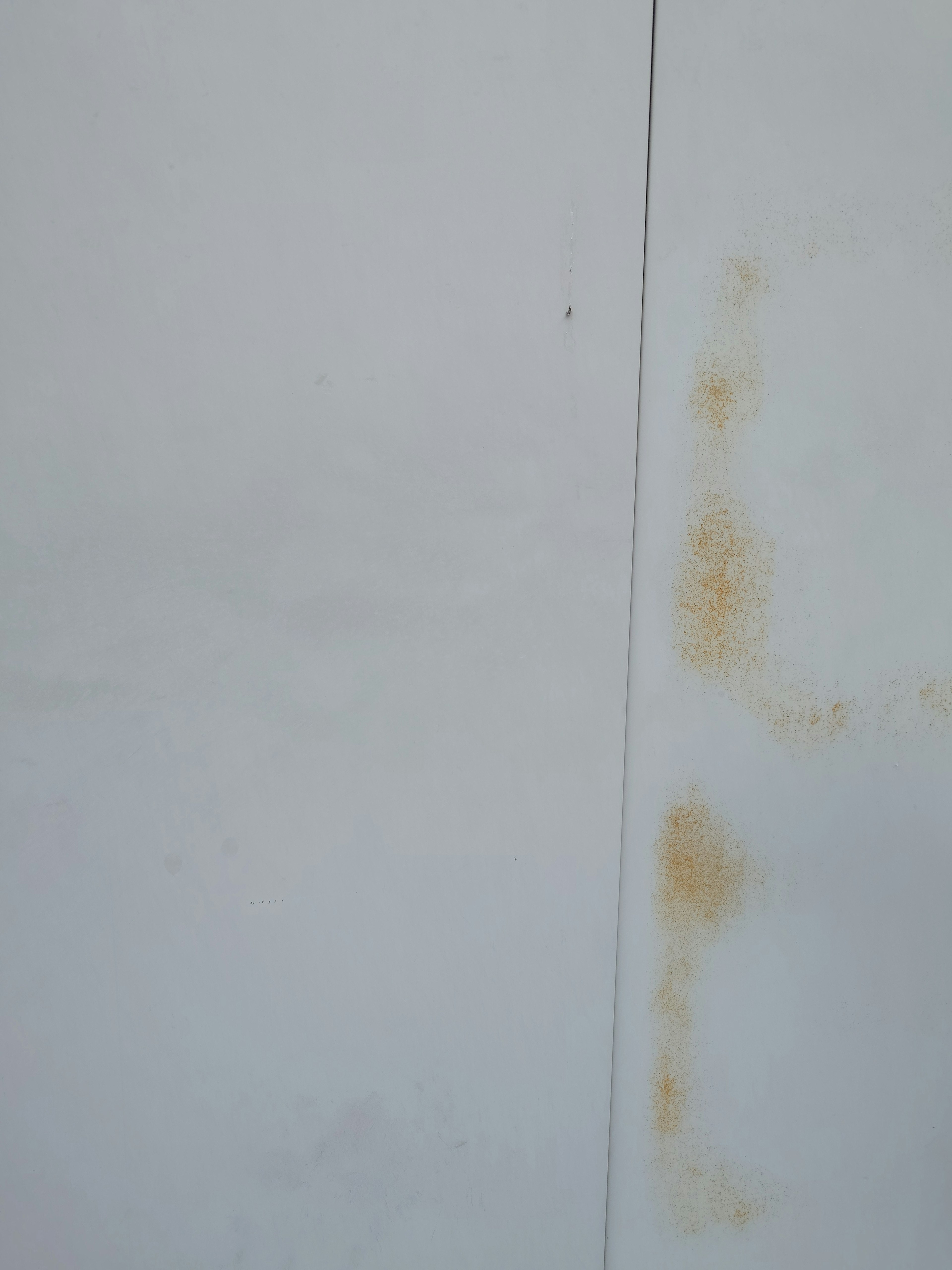 White wall with brown stains visible