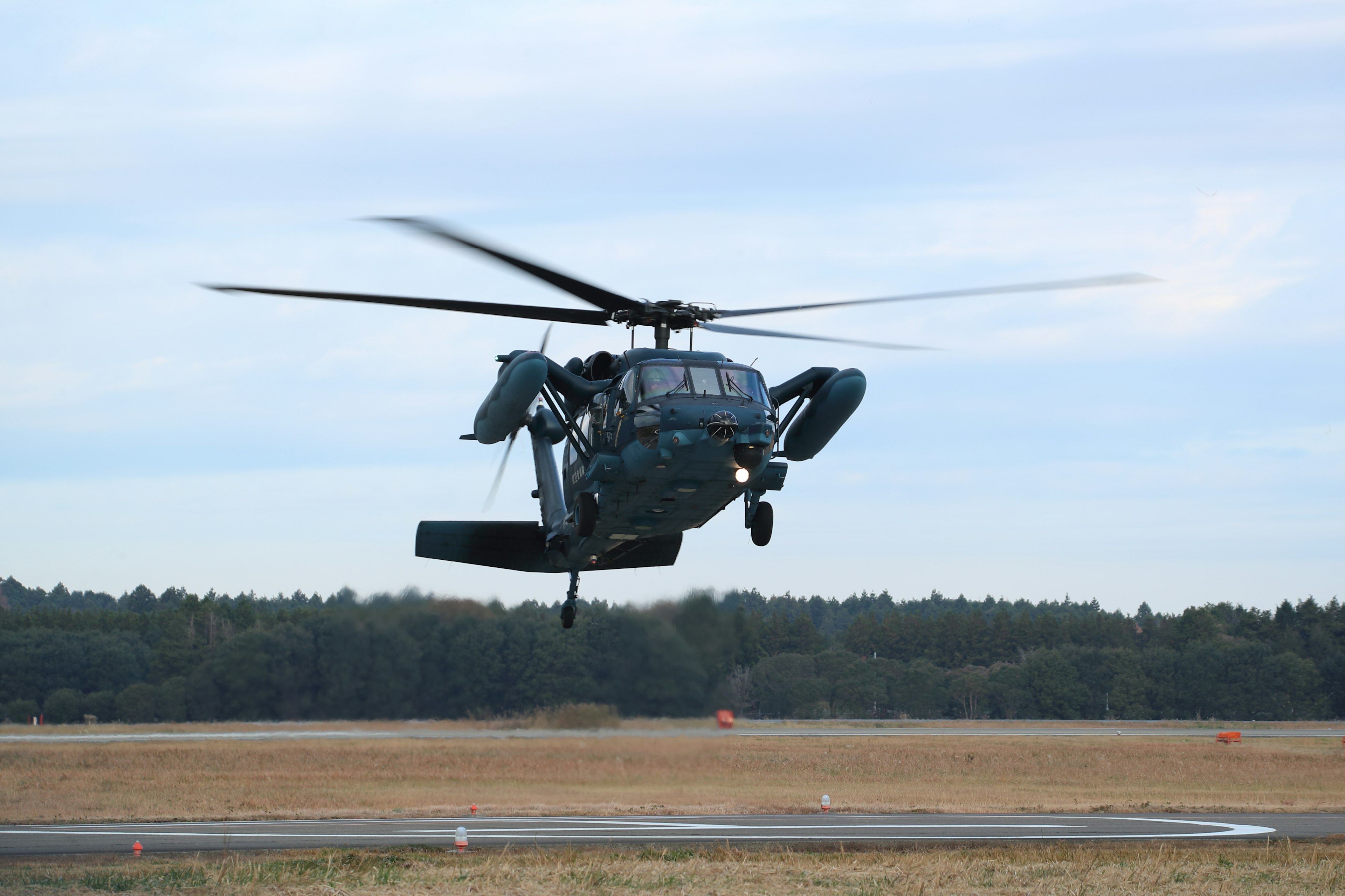 A helicopter taking off with spinning rotors