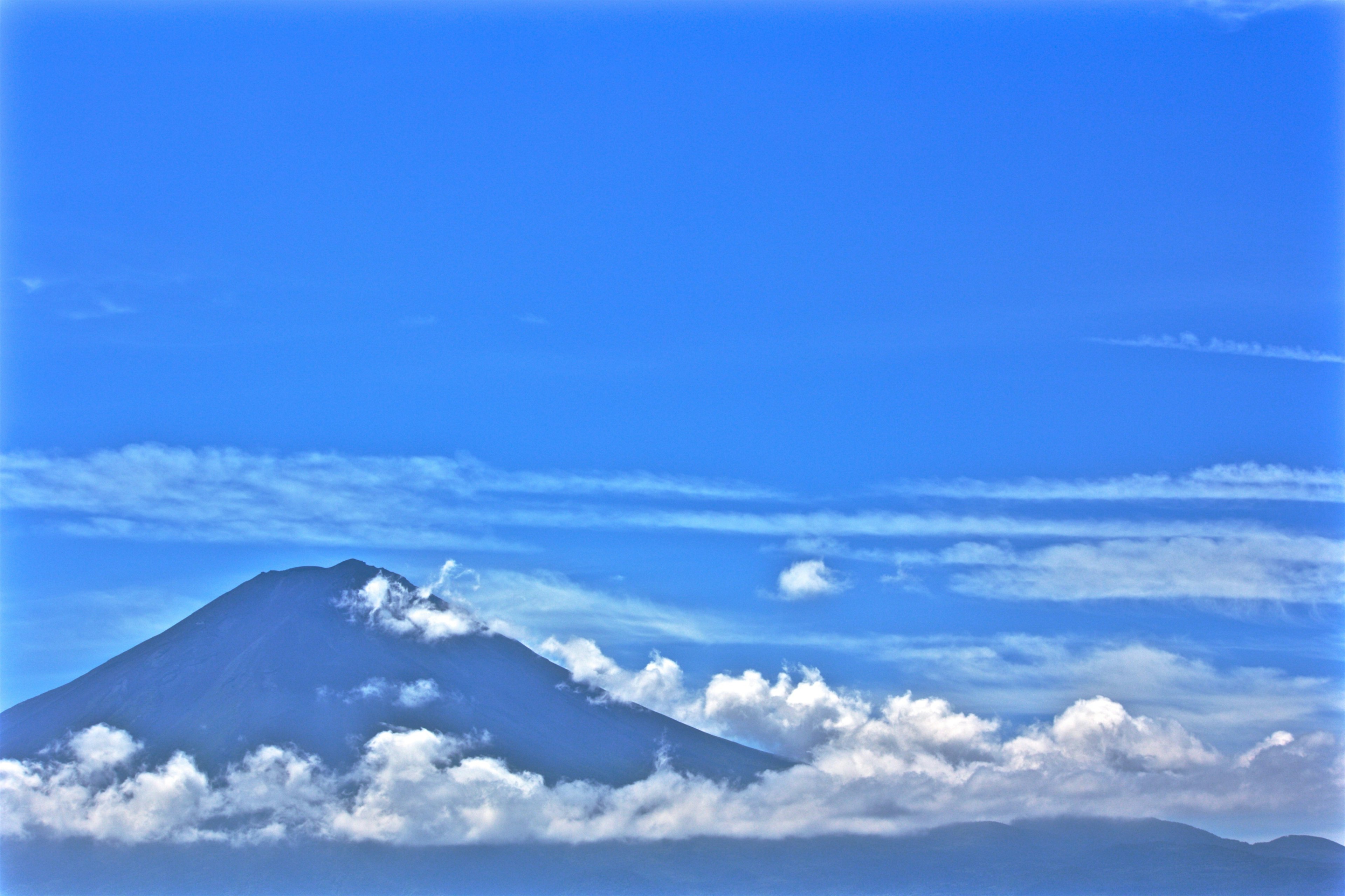 Montagne sous un ciel bleu clair avec des nuages