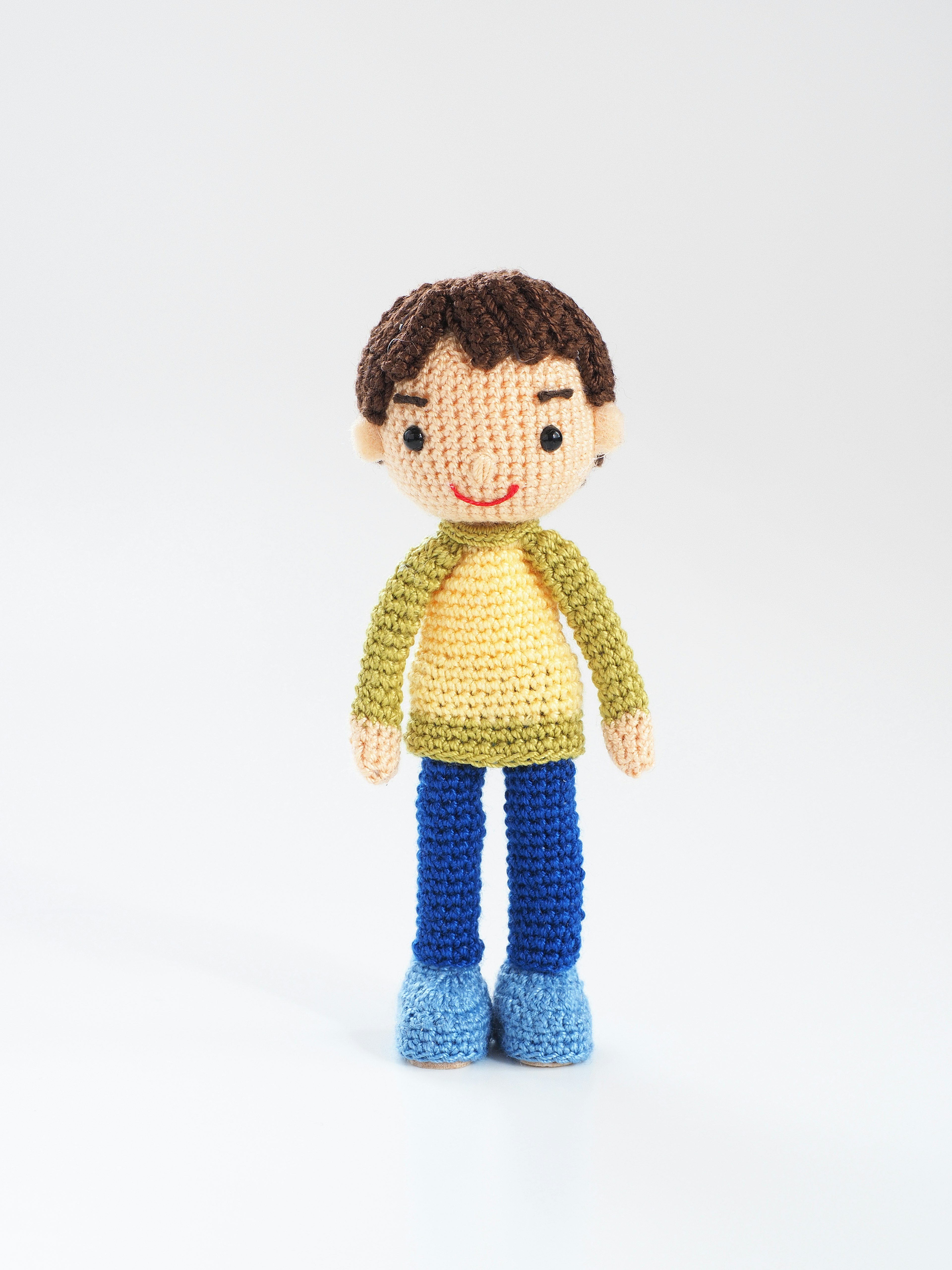 A colorful yarn doll standing upright