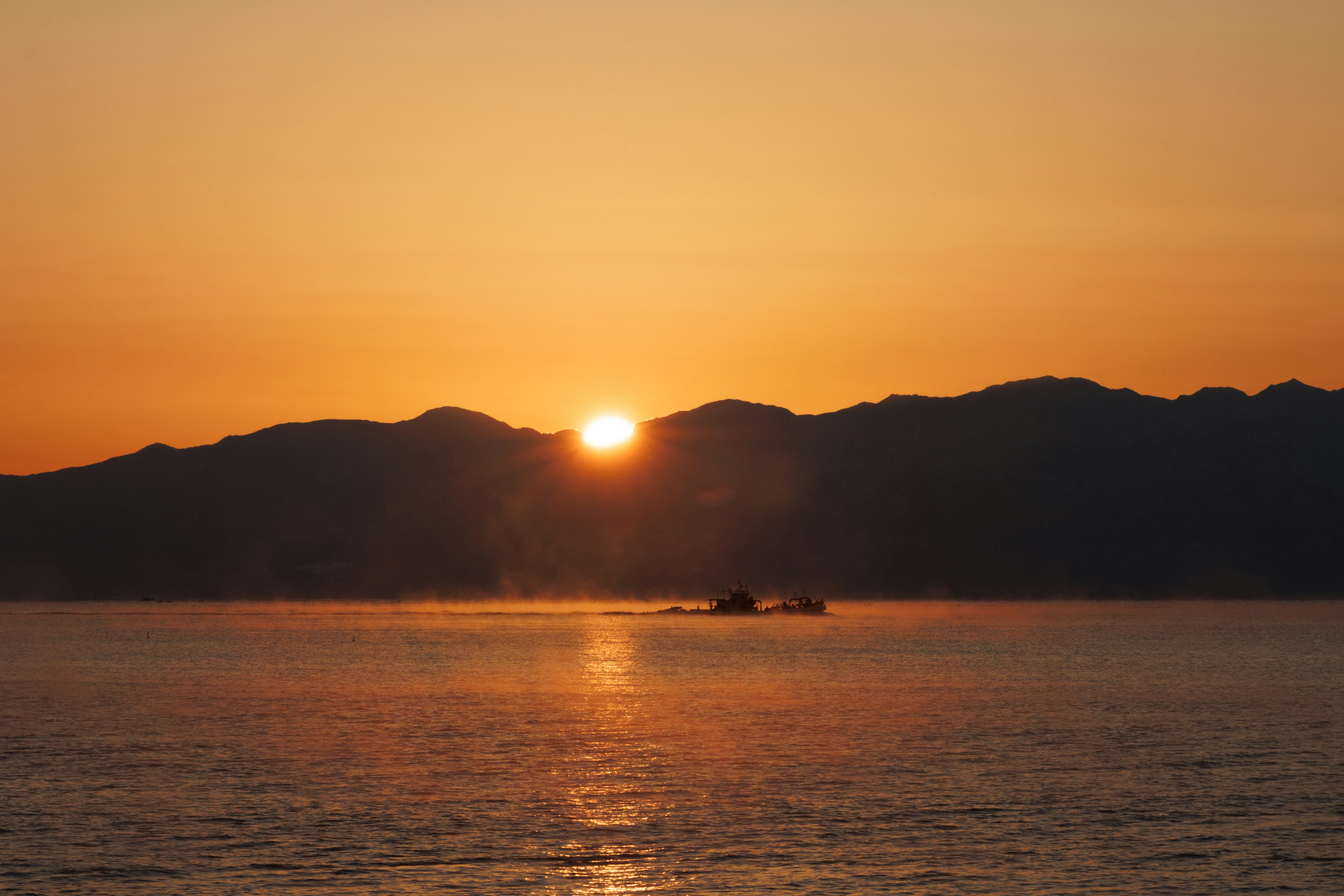 Beautiful landscape of the sunset rising between mountains