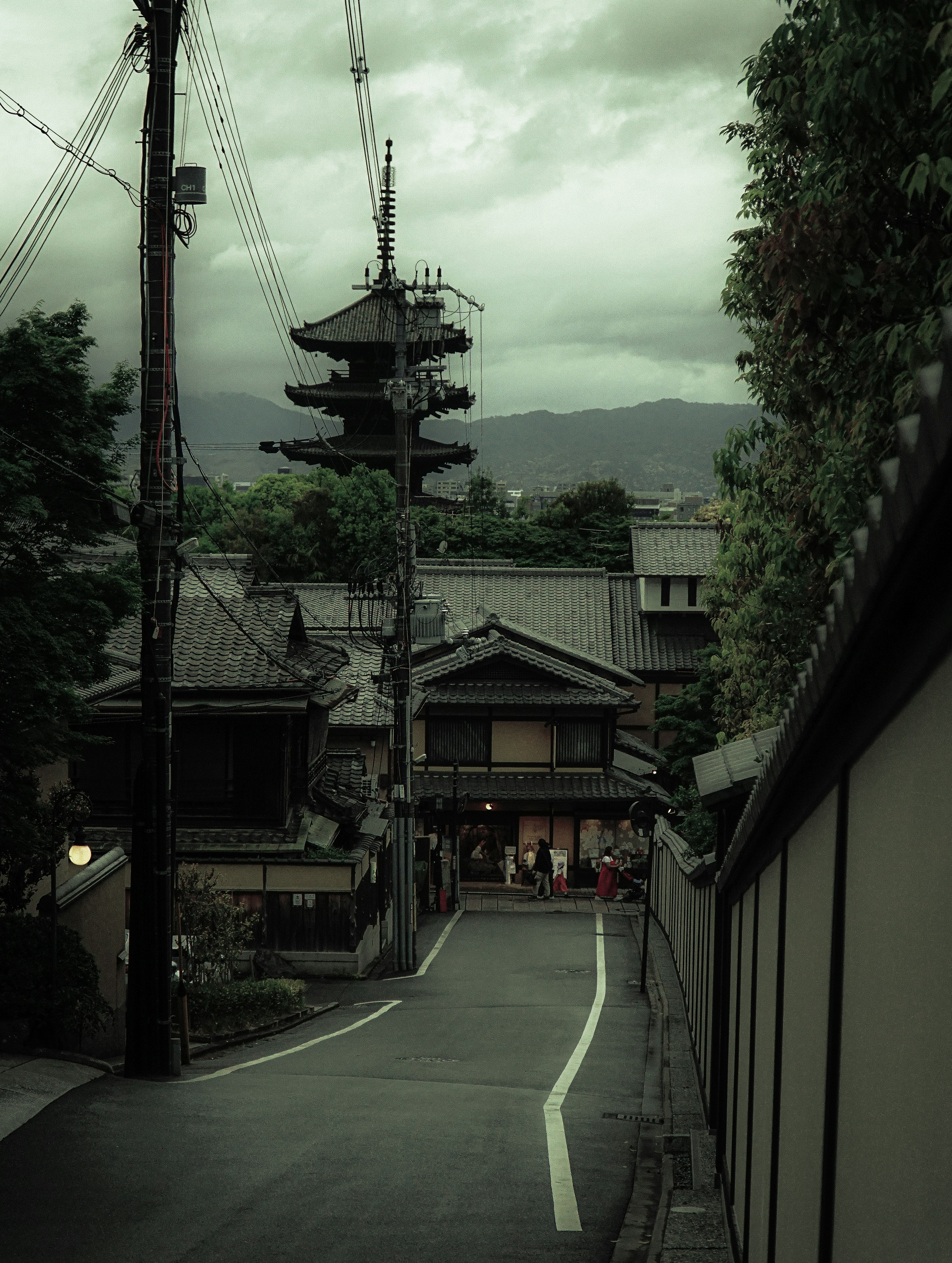 Quiet street scene featuring traditional Japanese architecture and a pagoda