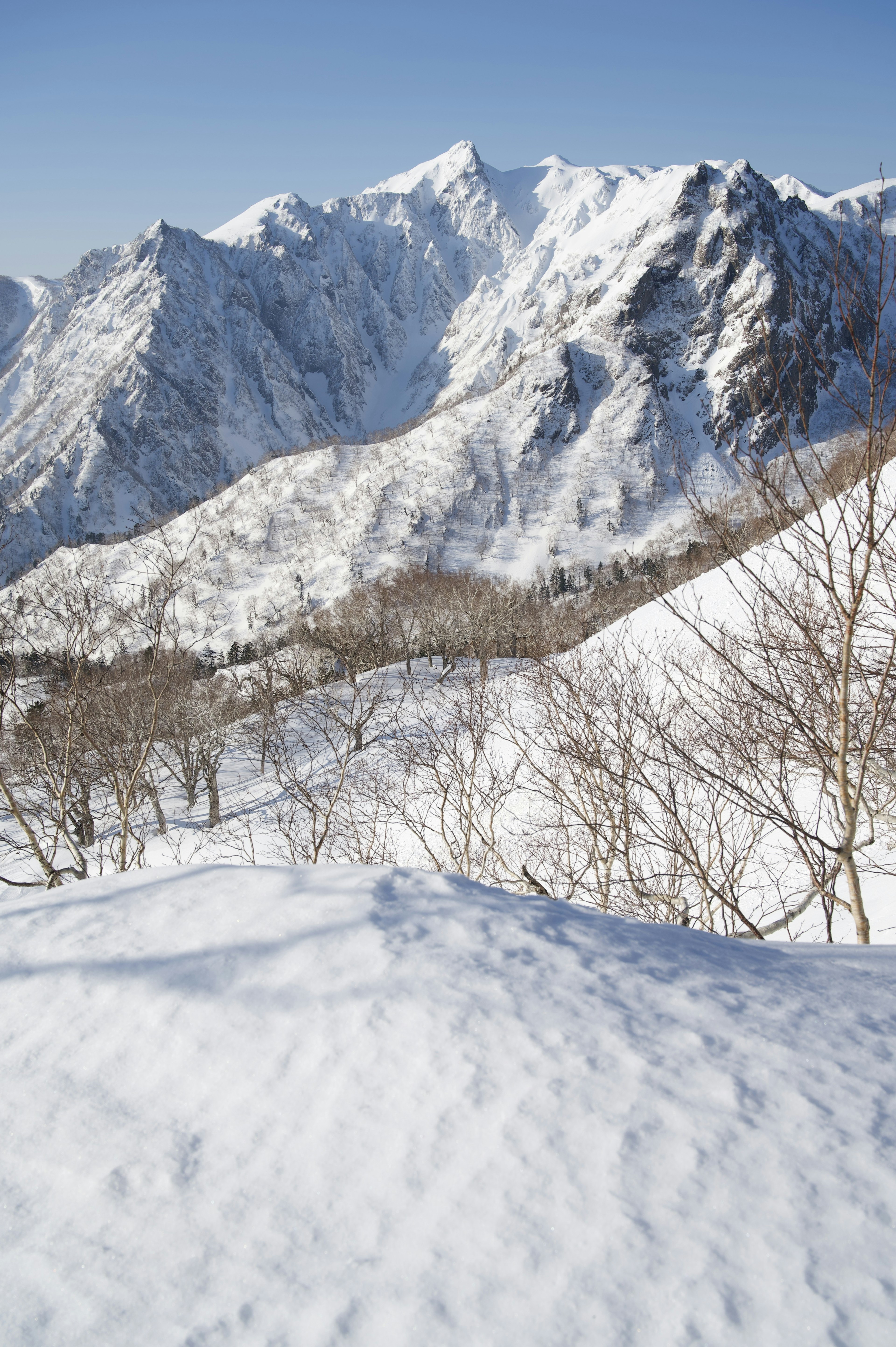 Beautiful snowy mountain landscape with clear blue sky