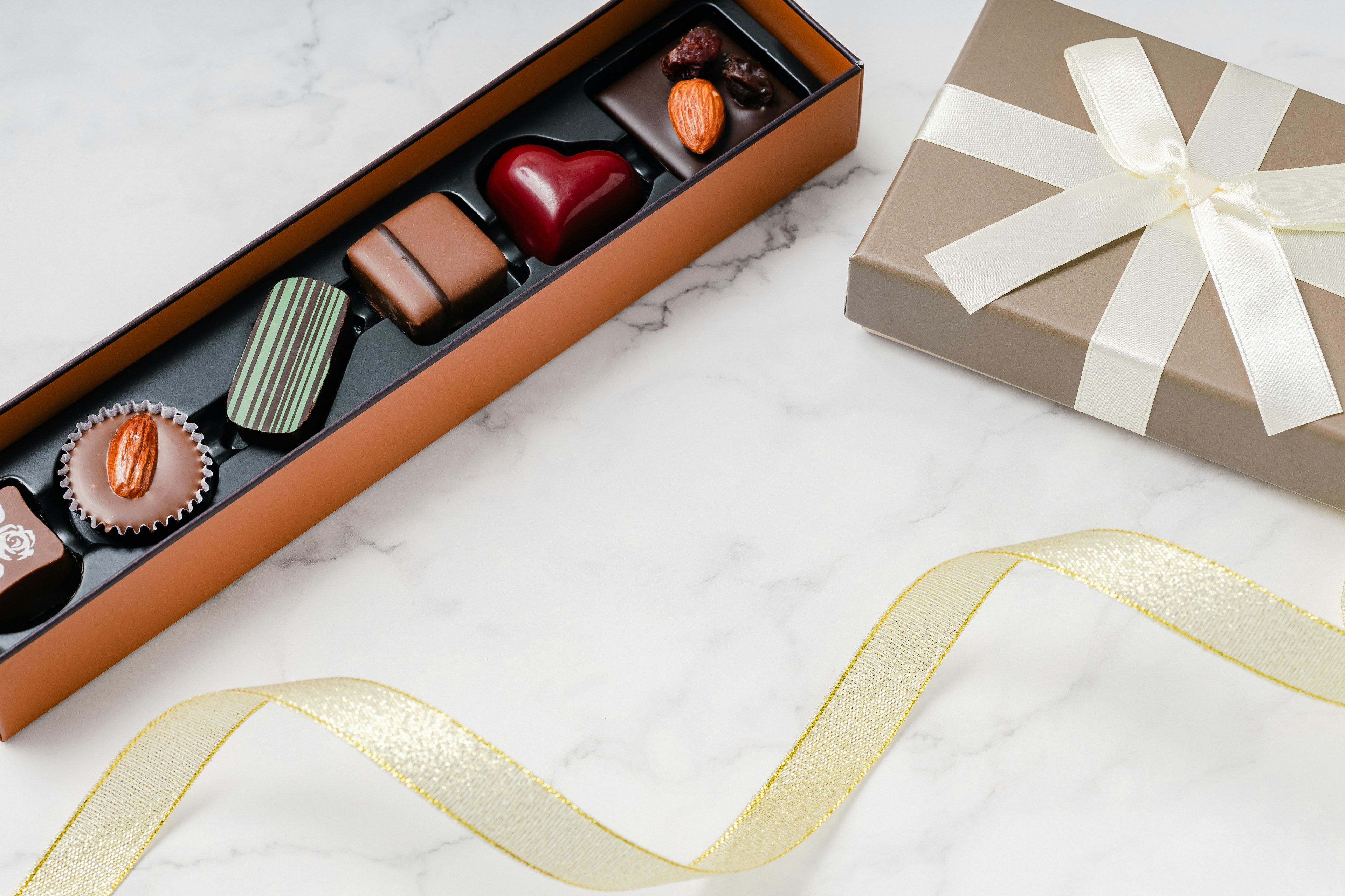 Chocolate assortment in a box with a gift-wrapped present