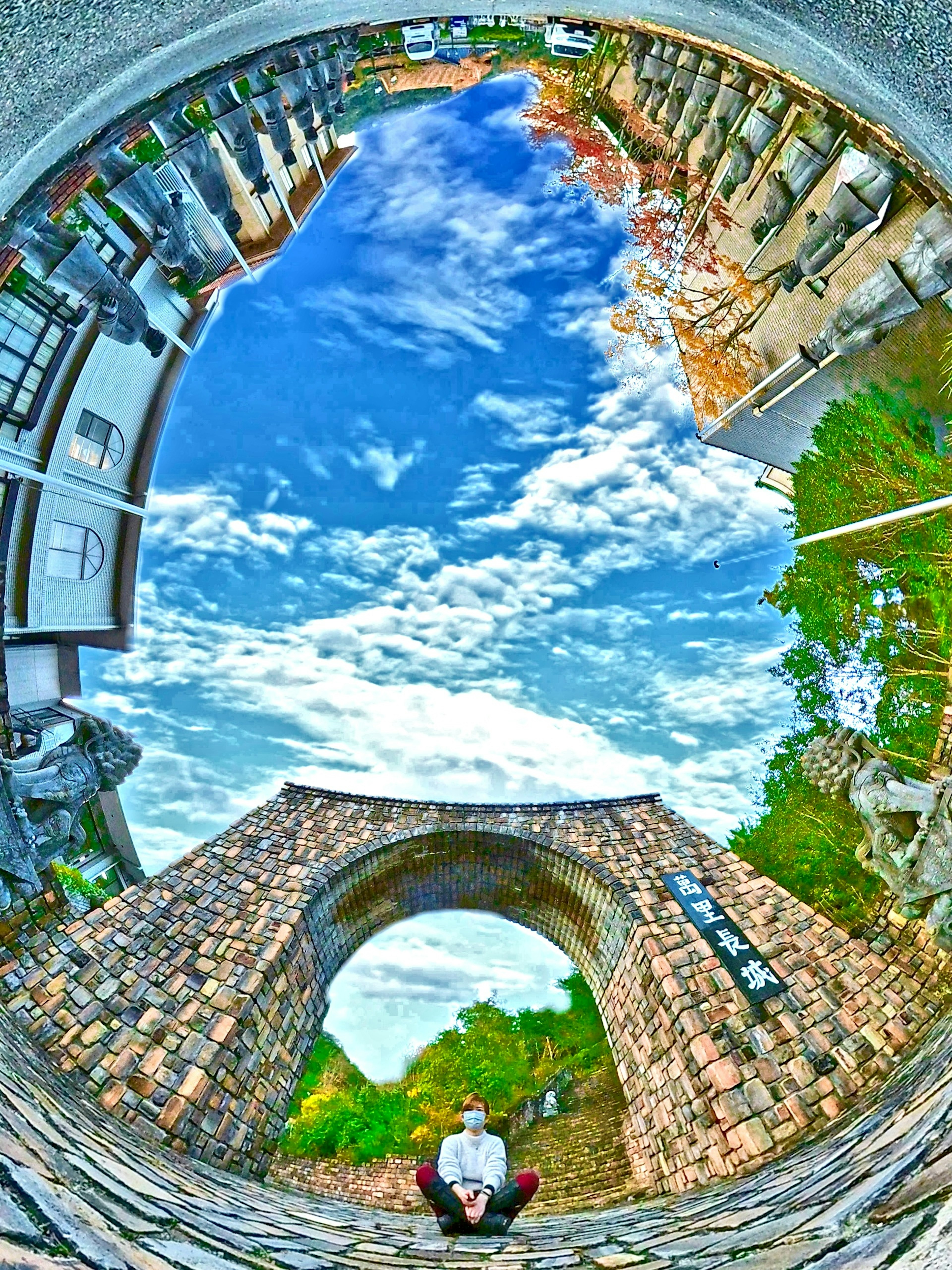 Unique perspective of a stone arch bridge and blue sky viewed from below