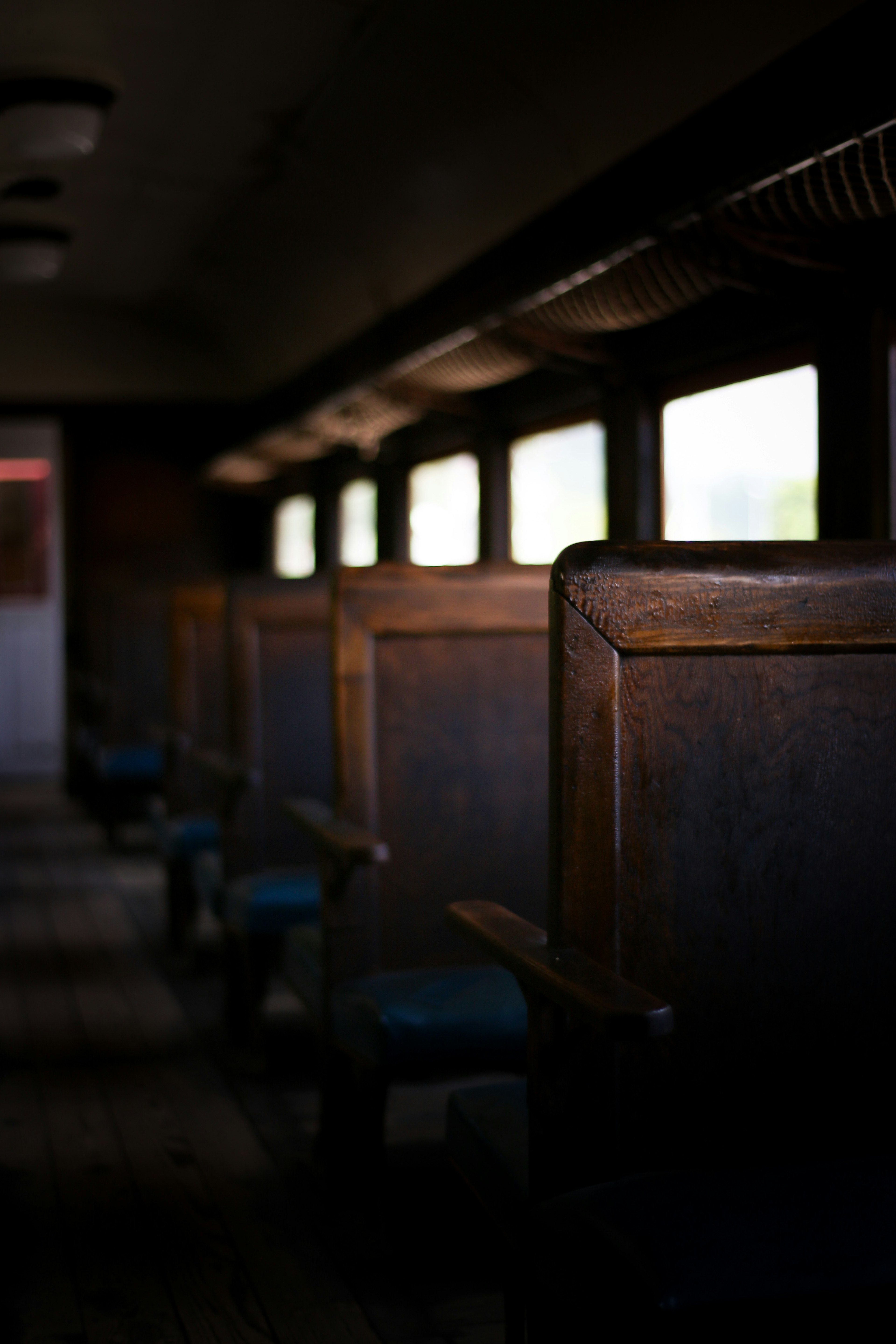 Interno di un vecchio vagone ferroviario con sedili in legno