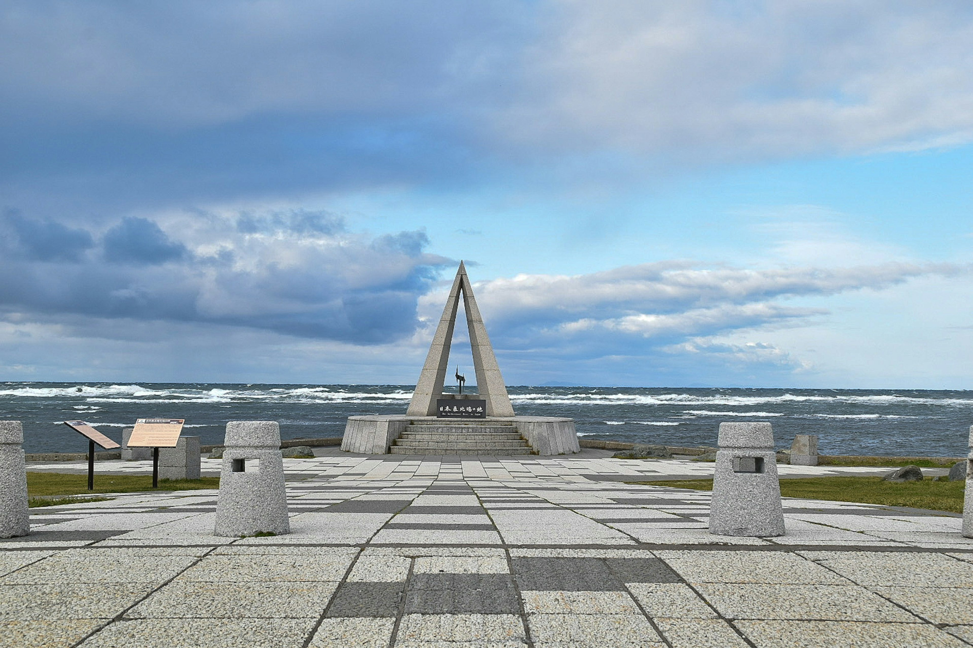 Scenic view featuring a monument facing the sea with stone structures